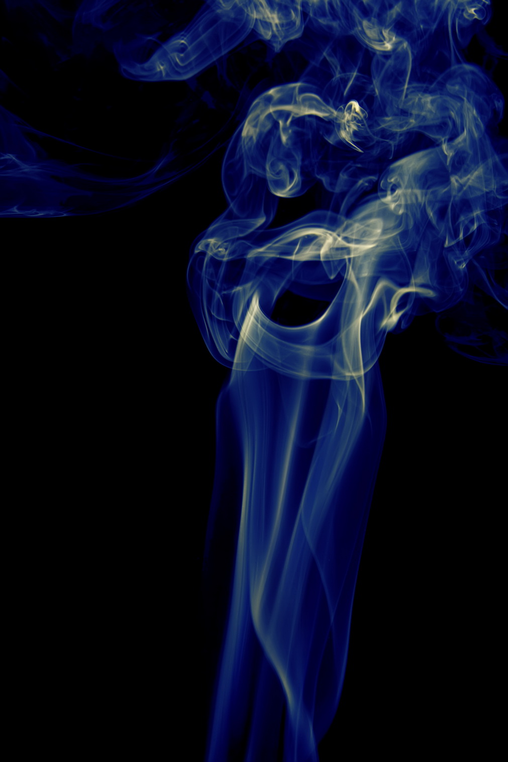 Blue smoke on black photo