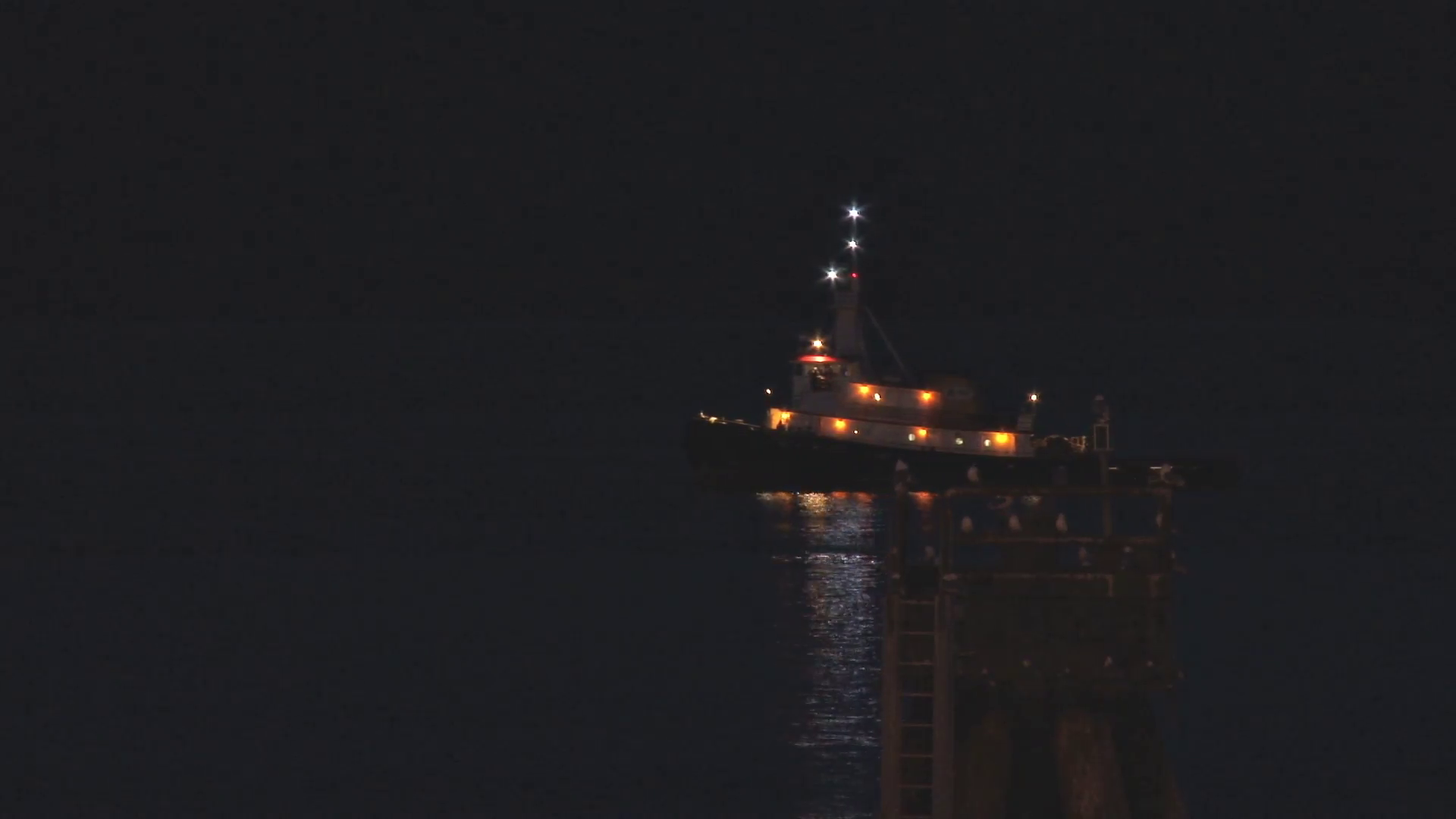 Tug Boat at Night moving past deepwater mooring Stock Video Footage ...