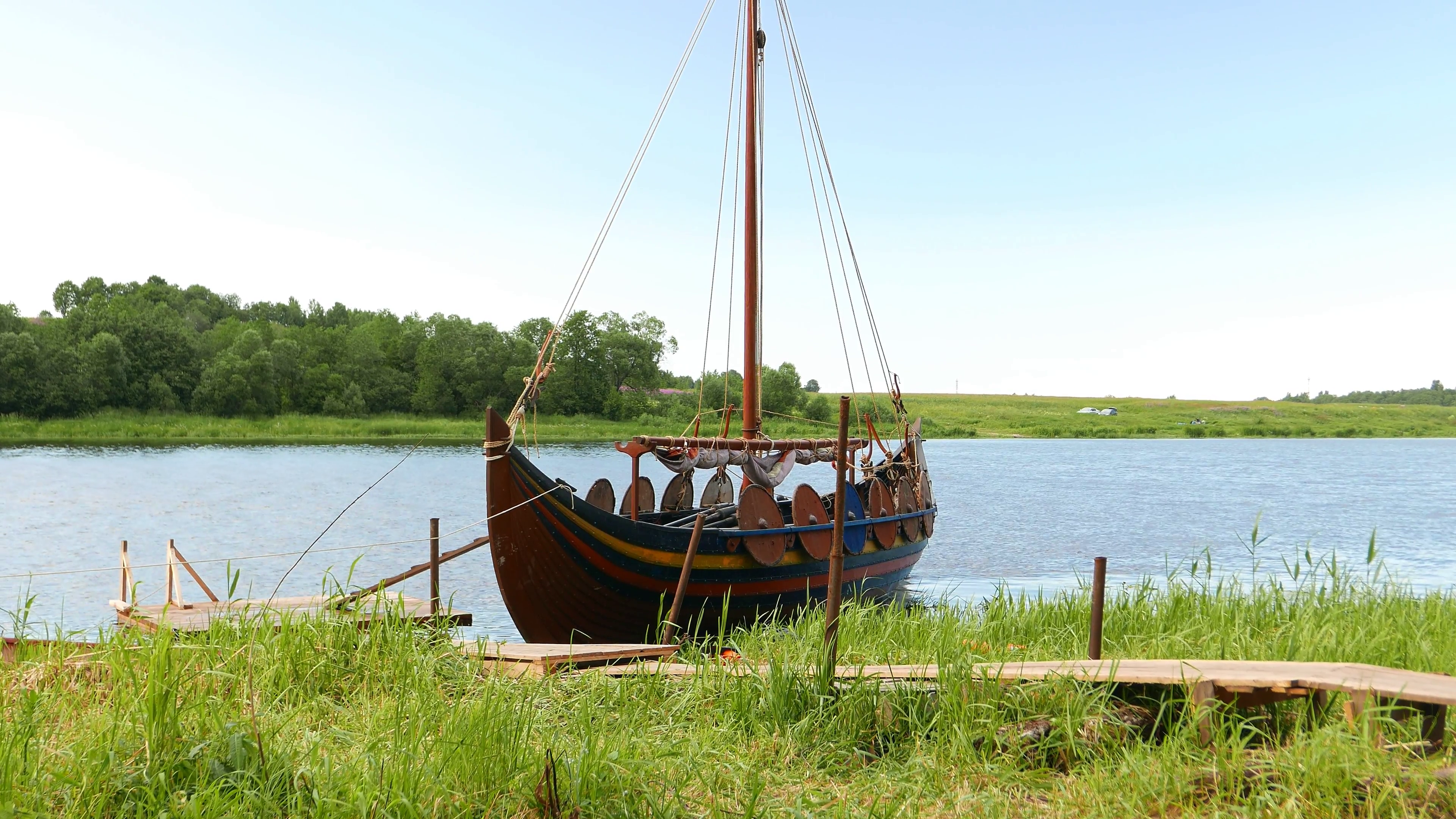 Traditional Viking longship boat, Karvi, stand at green river shore ...