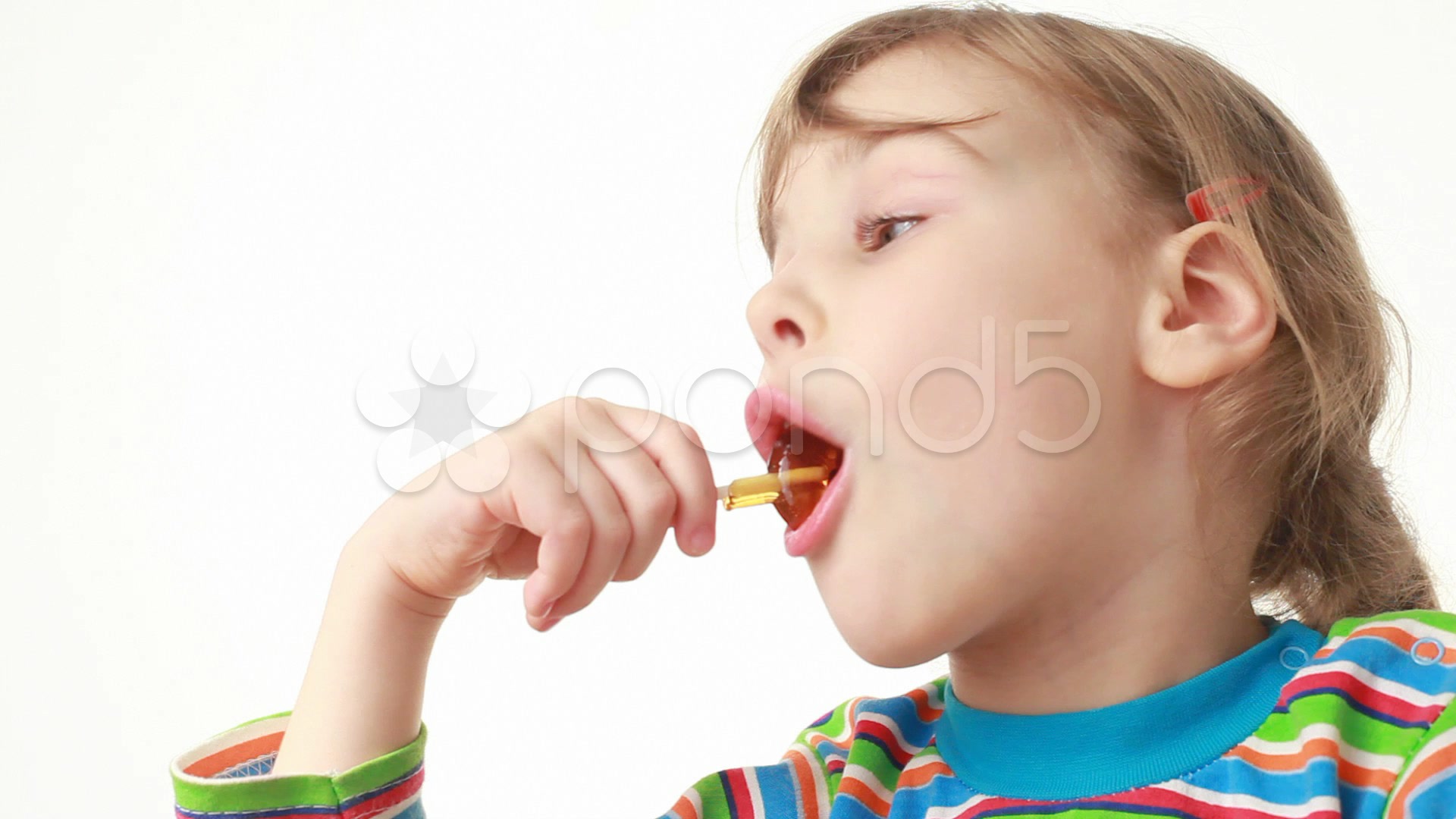 Little girl eating lollipop in chicken form ~ Clip #981022