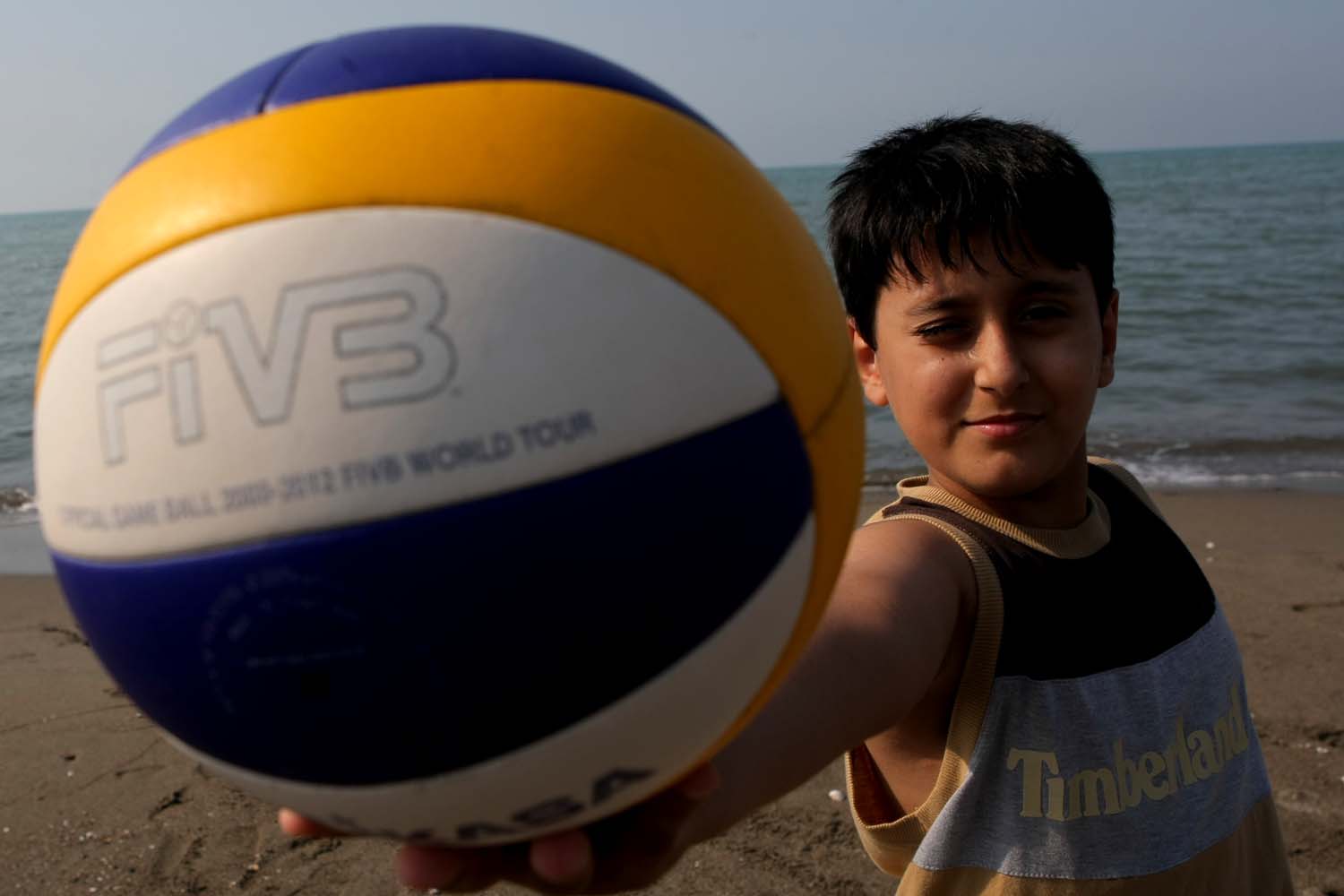Boy holding a volleyball photo