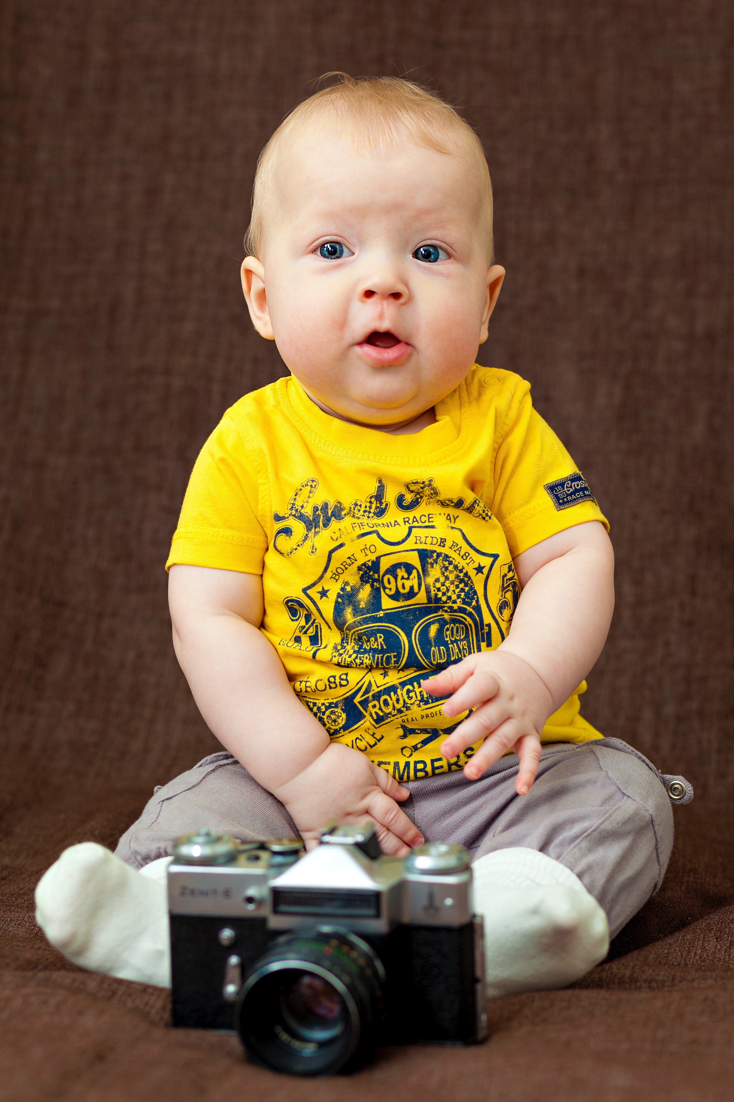 Boy in yellow crew-neck t-shirt and gray bottoms photo