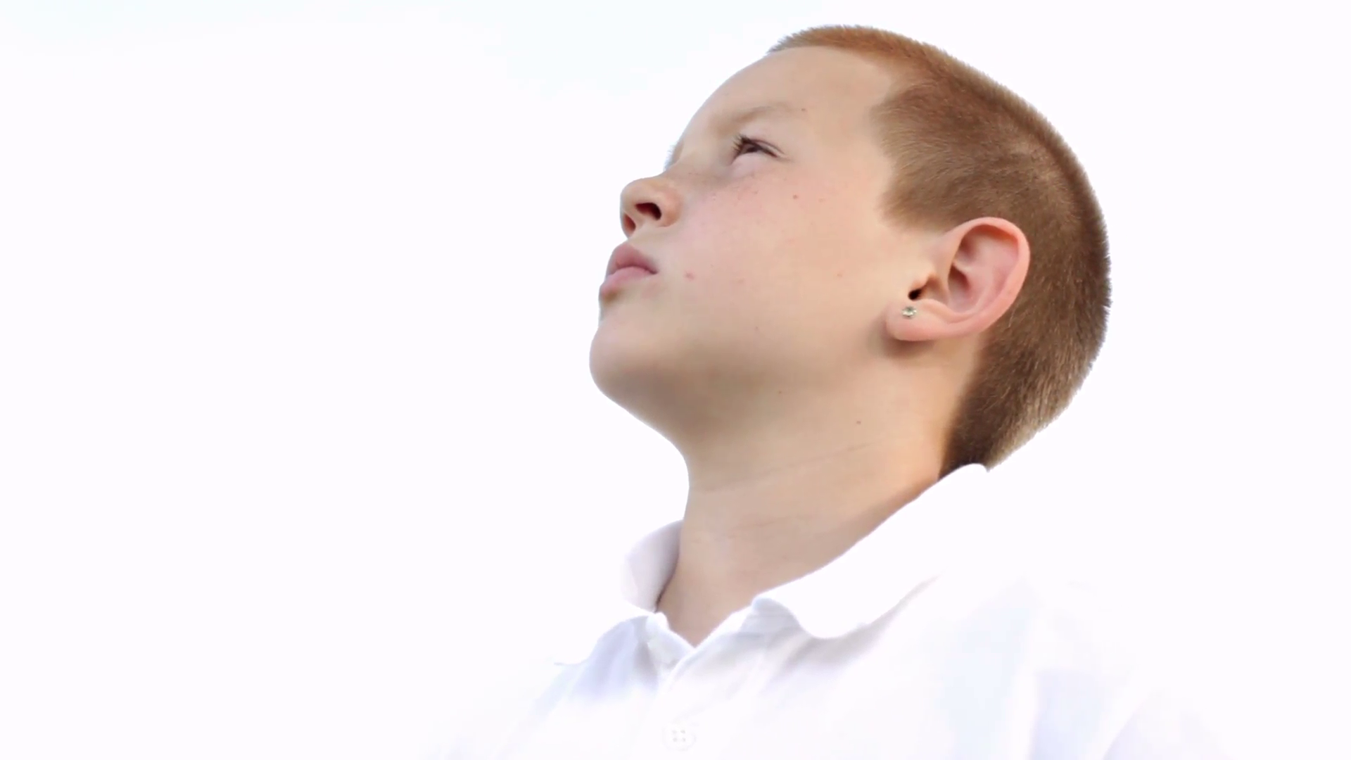 Young boy on white background looking up into distance Stock Video ...