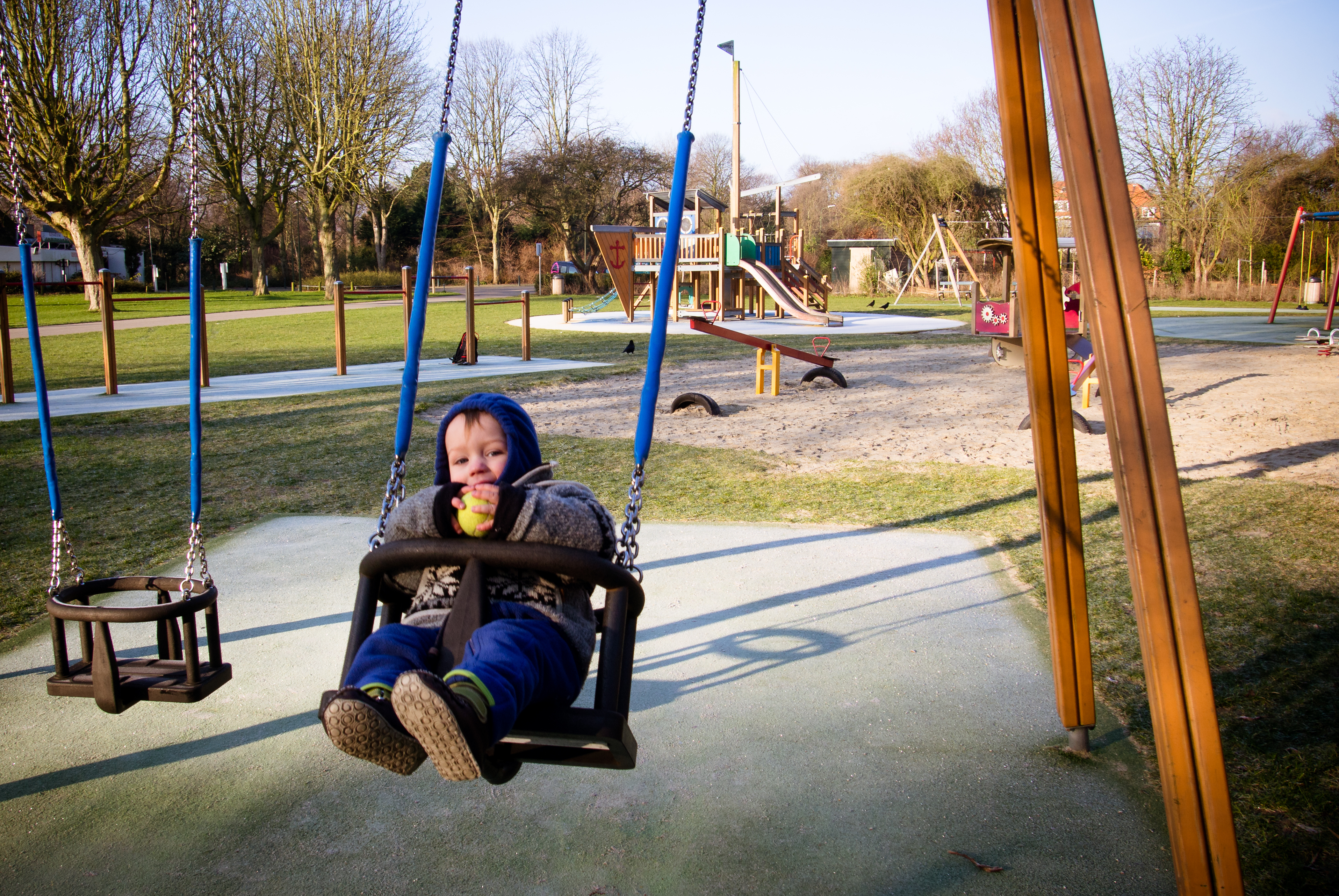 Boy on swing in playground photo