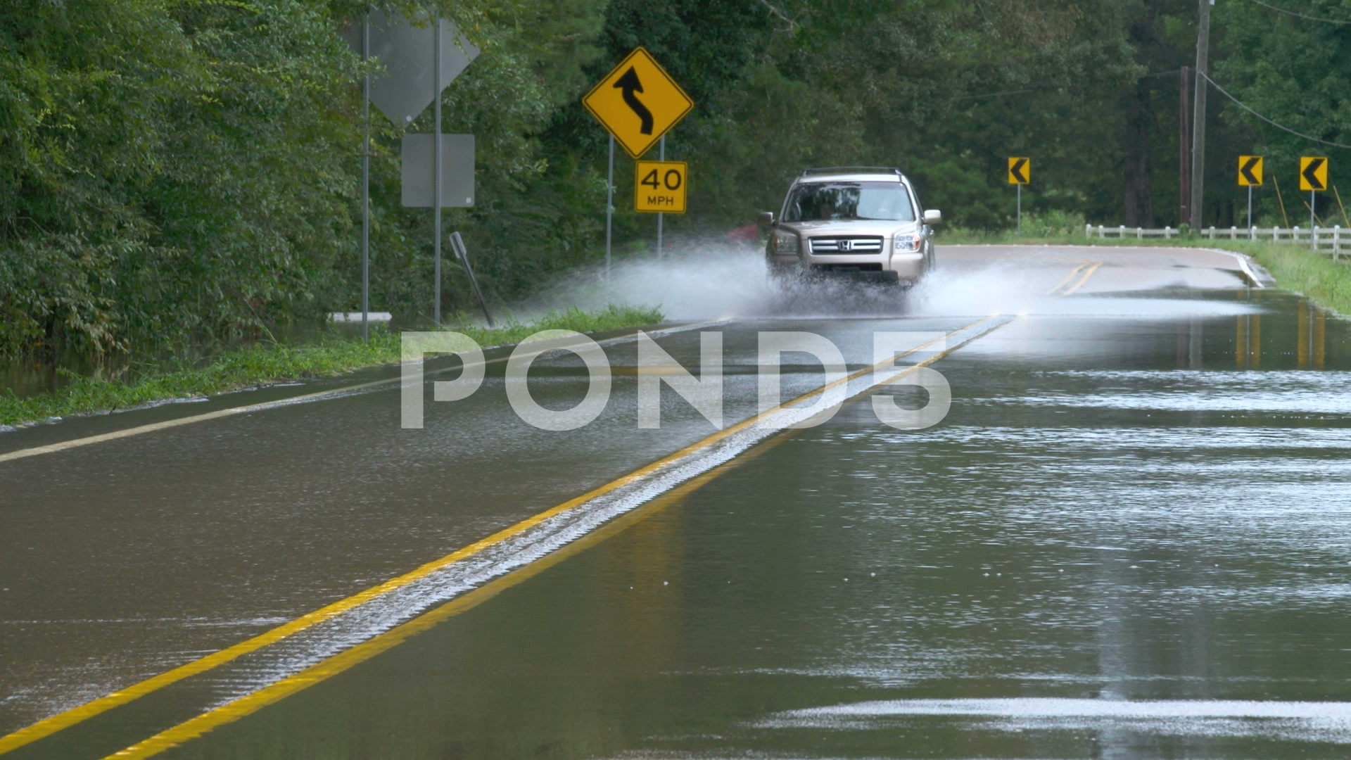 Video: Car braving flooded wet road from catastrophic flooding ...