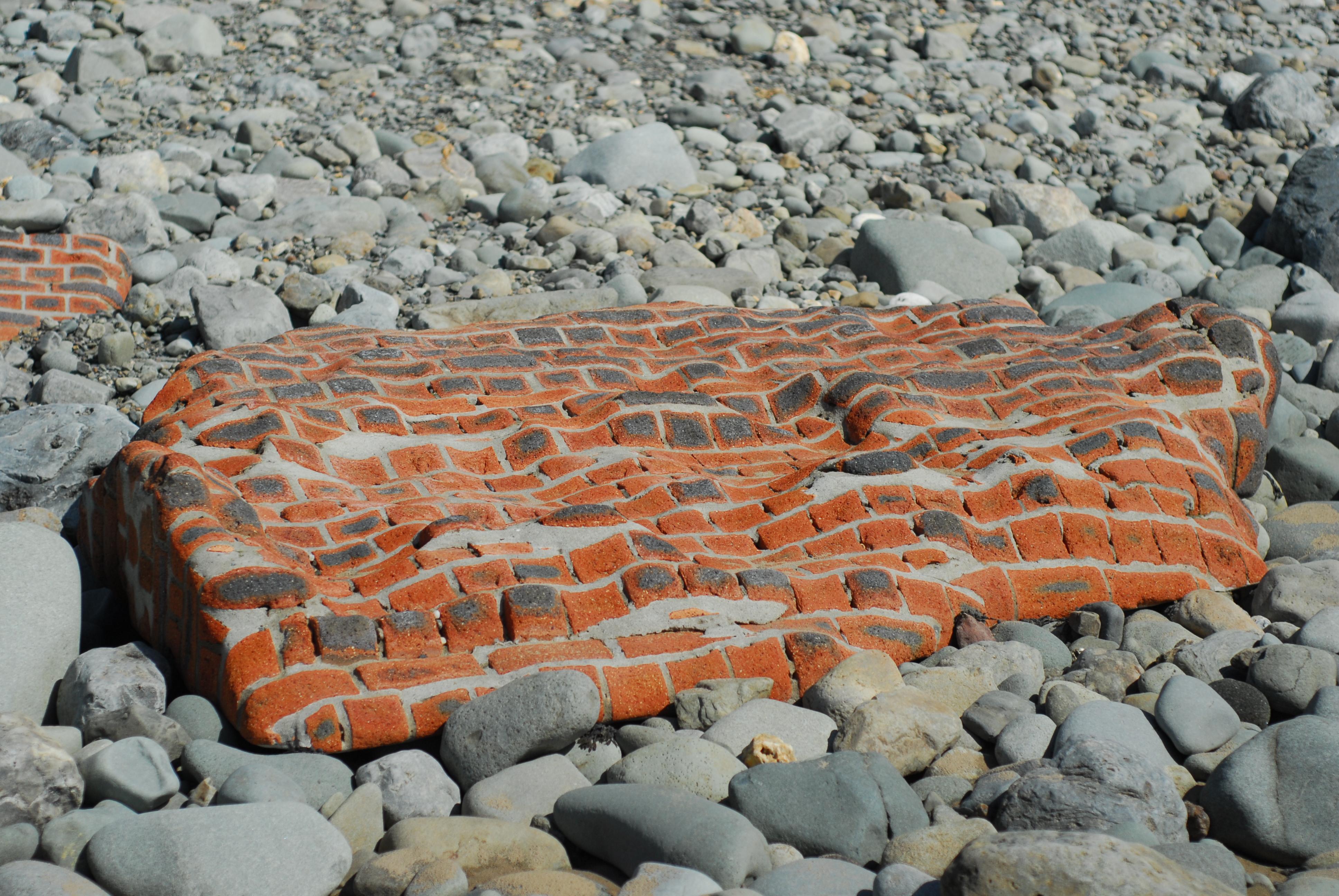 This whole brick wall which has been shaped by the sea ...