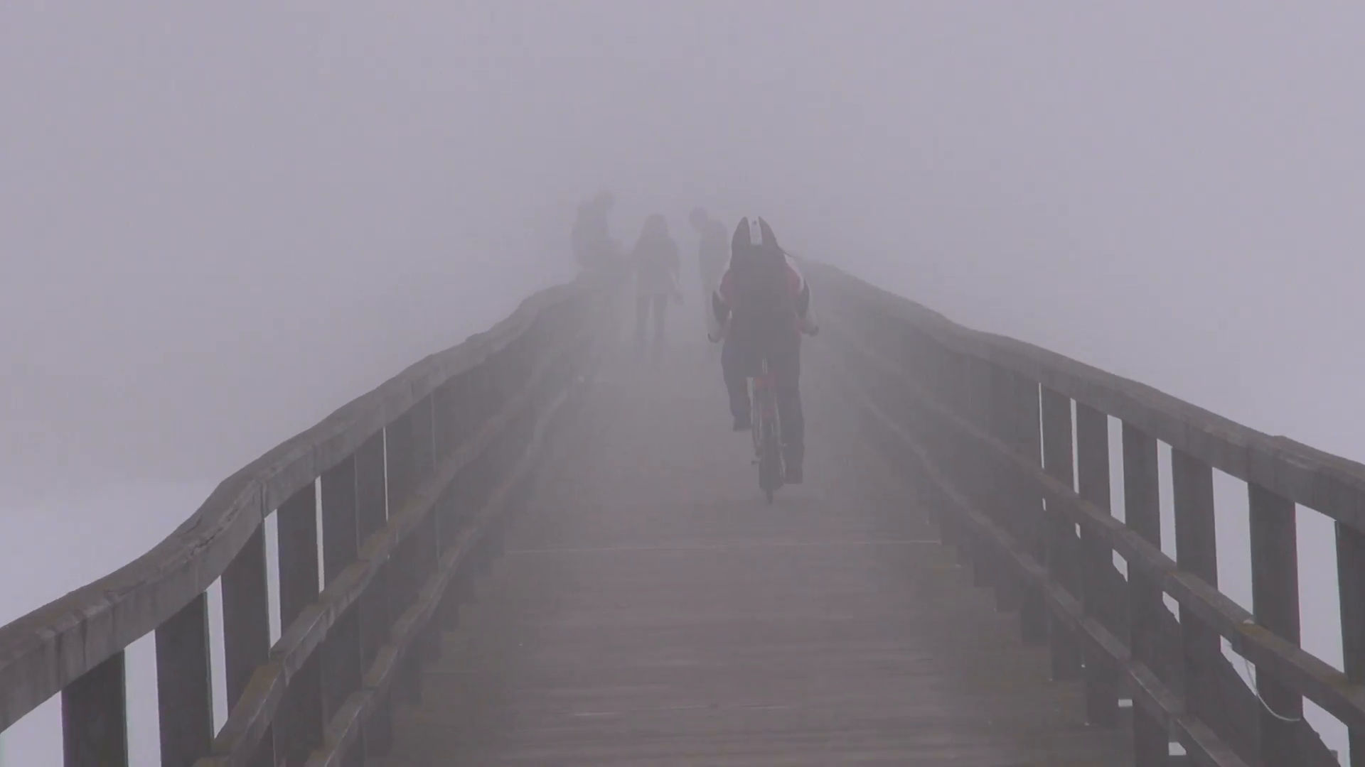 wooden bridge in winter mist fog and bicyclist Stock Video Footage ...