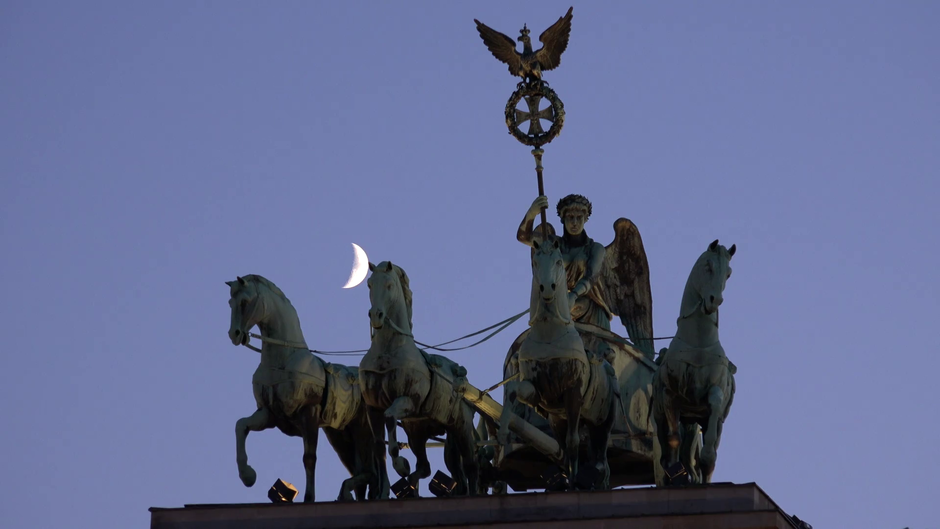 4K Closeup crescent moon at quadriga statue Brandenburg Gate Berlin ...