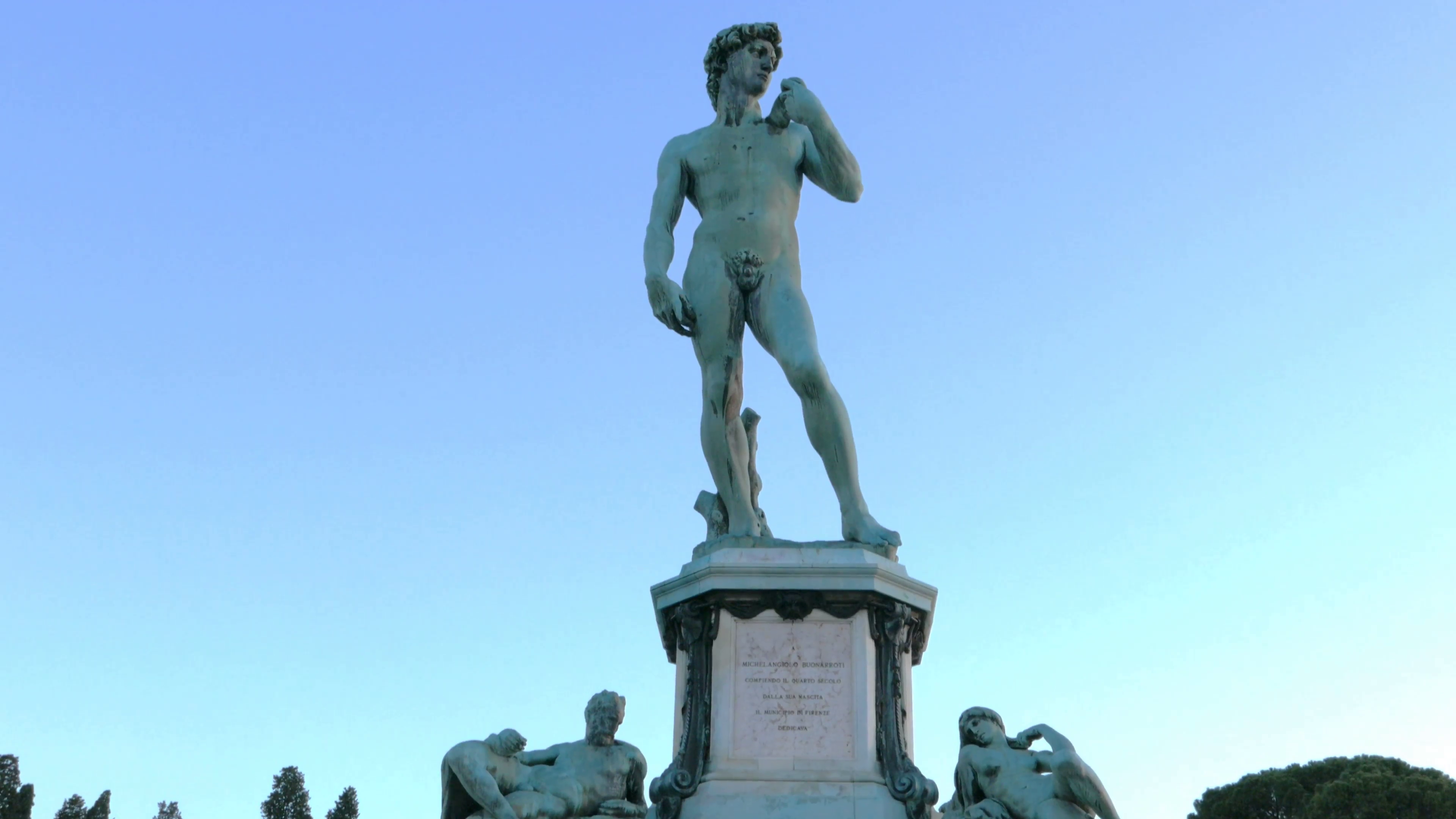 a tilt up gimbal shot of the bronze statue of david in florence ...
