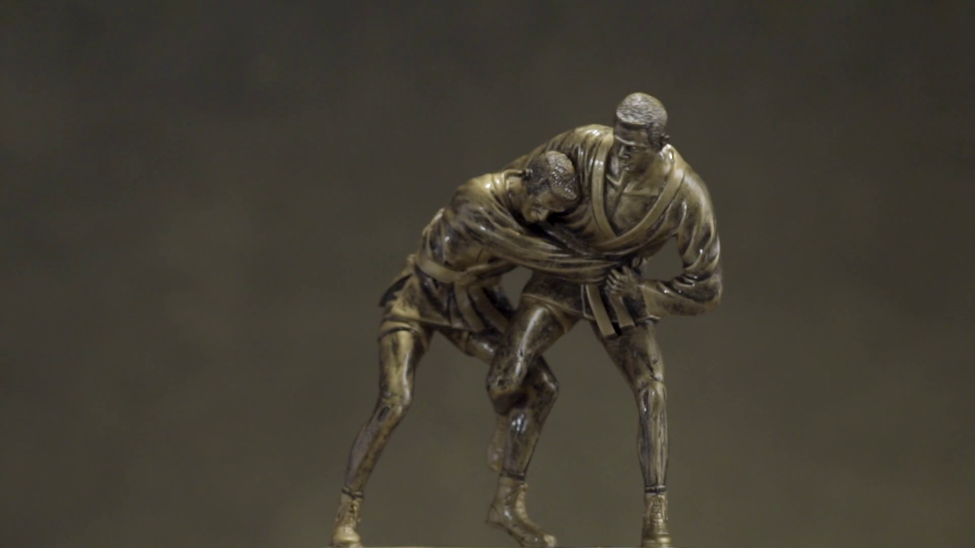 Bronze statuette of two men wrestling with each other close up ...