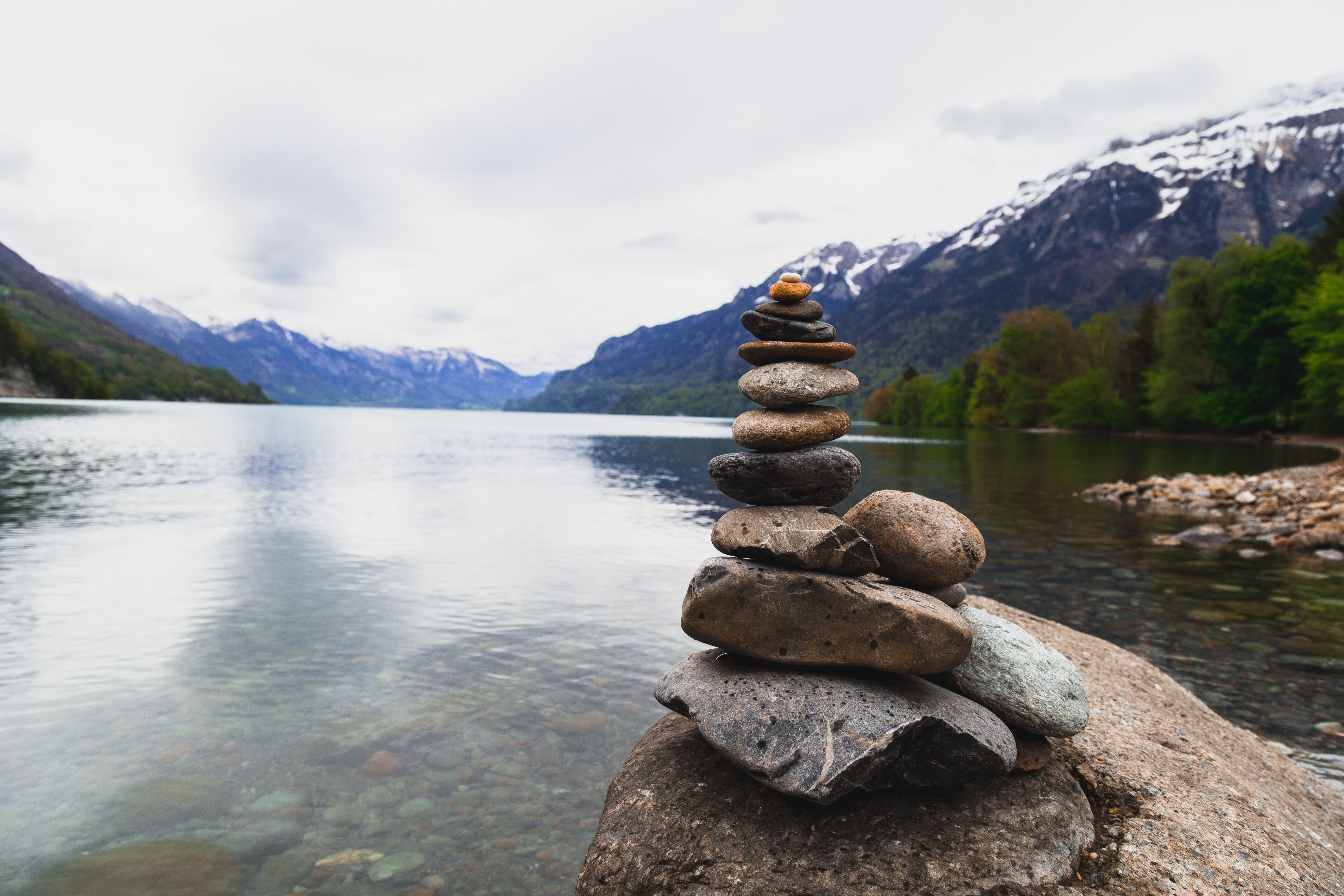 Brown and gray stone stack near body of water photo