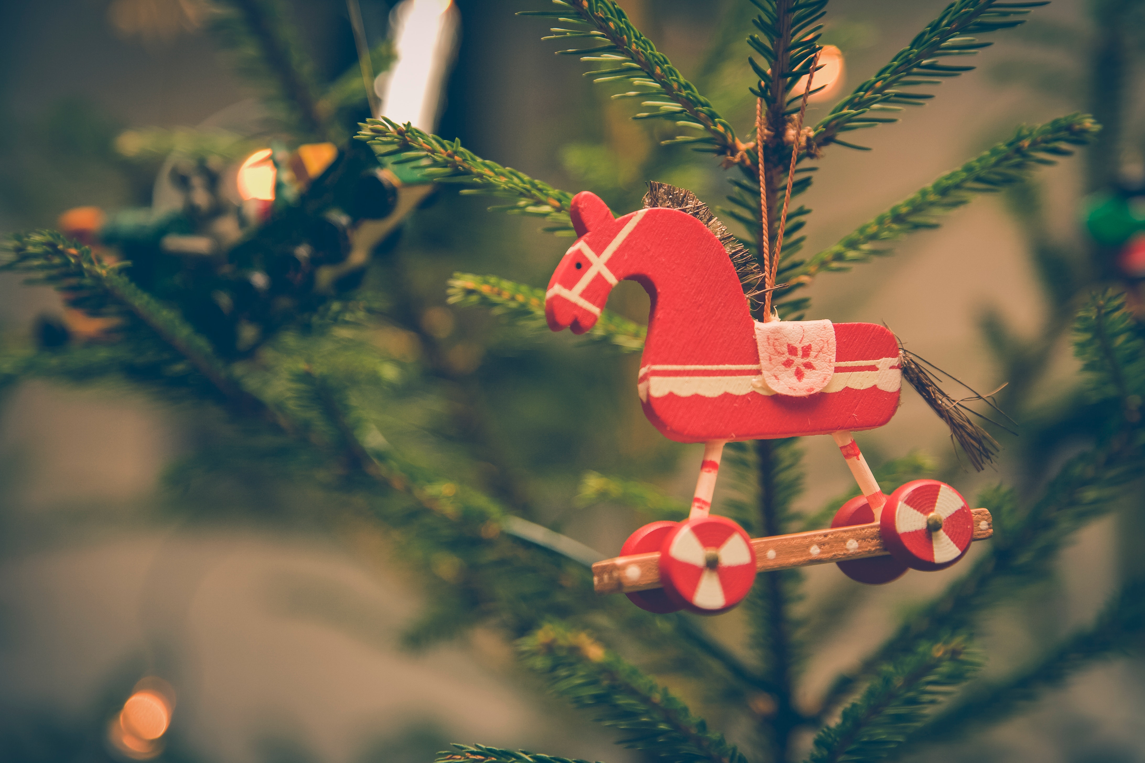 Brown and red horse decor hanged on christmas tree photo