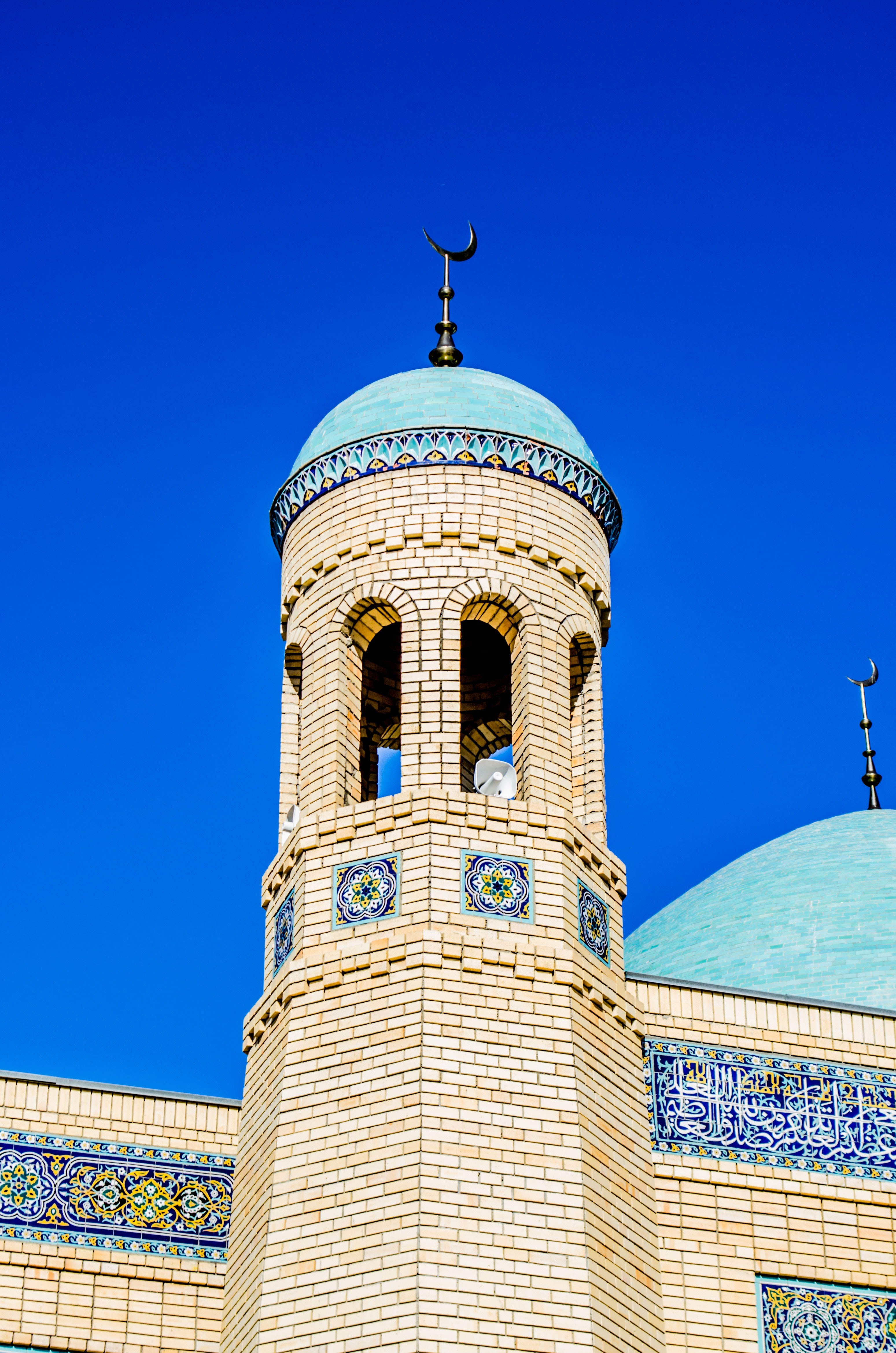 Brown concrete mosque under blue sky during daytime photo