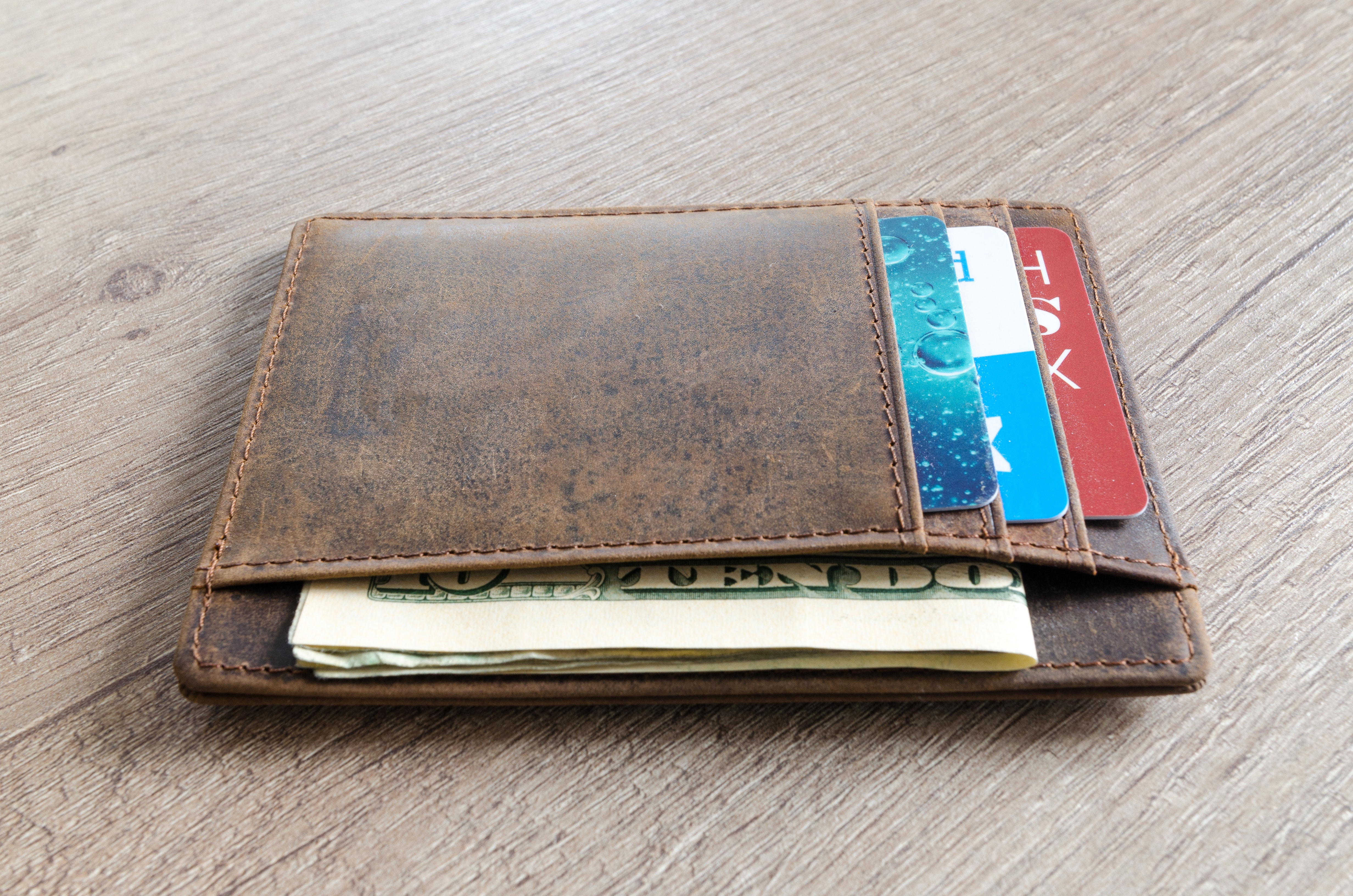 Brown leather wallet and us dollar banknote photo