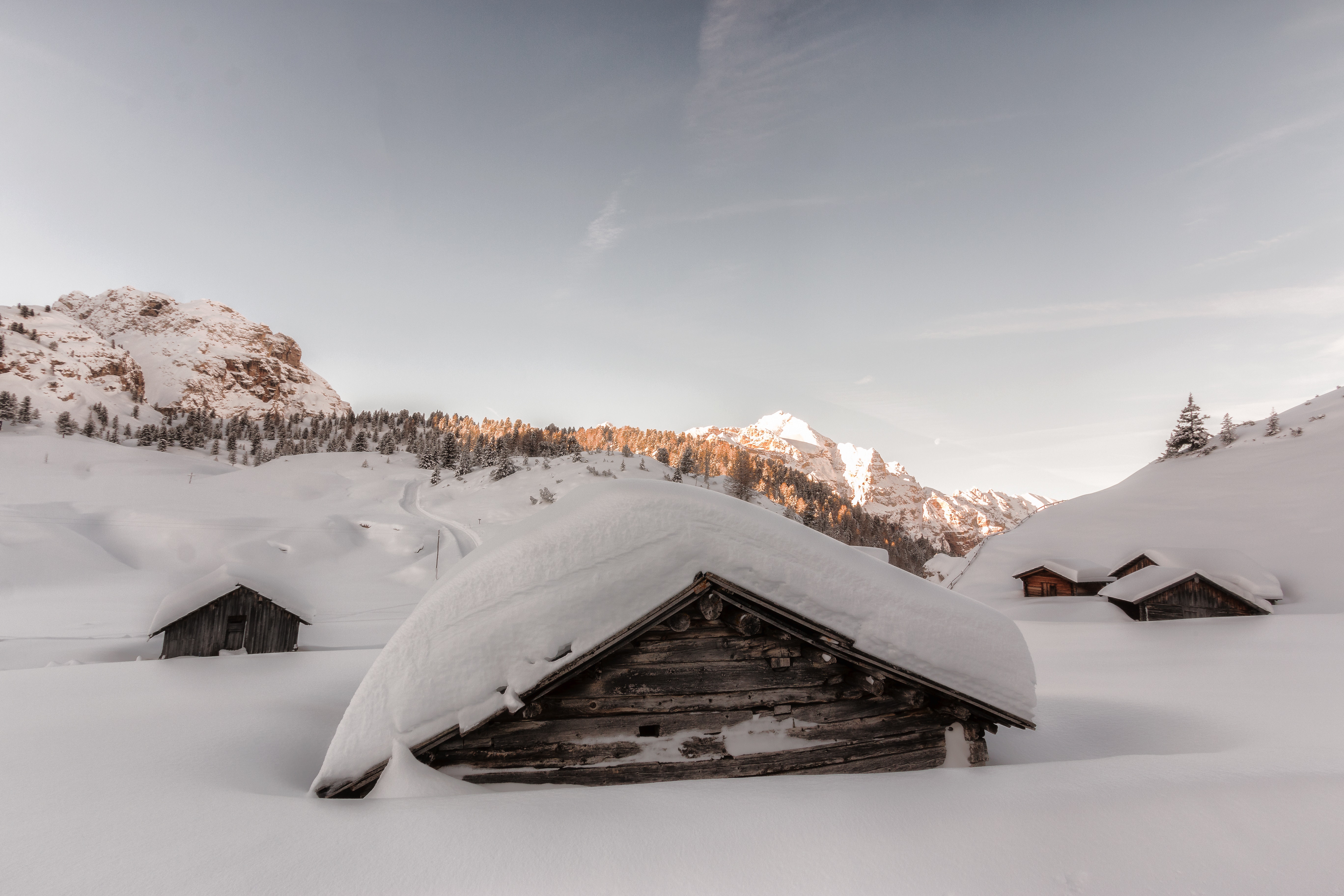 Brown wooden houses covered in snow at daytime photo