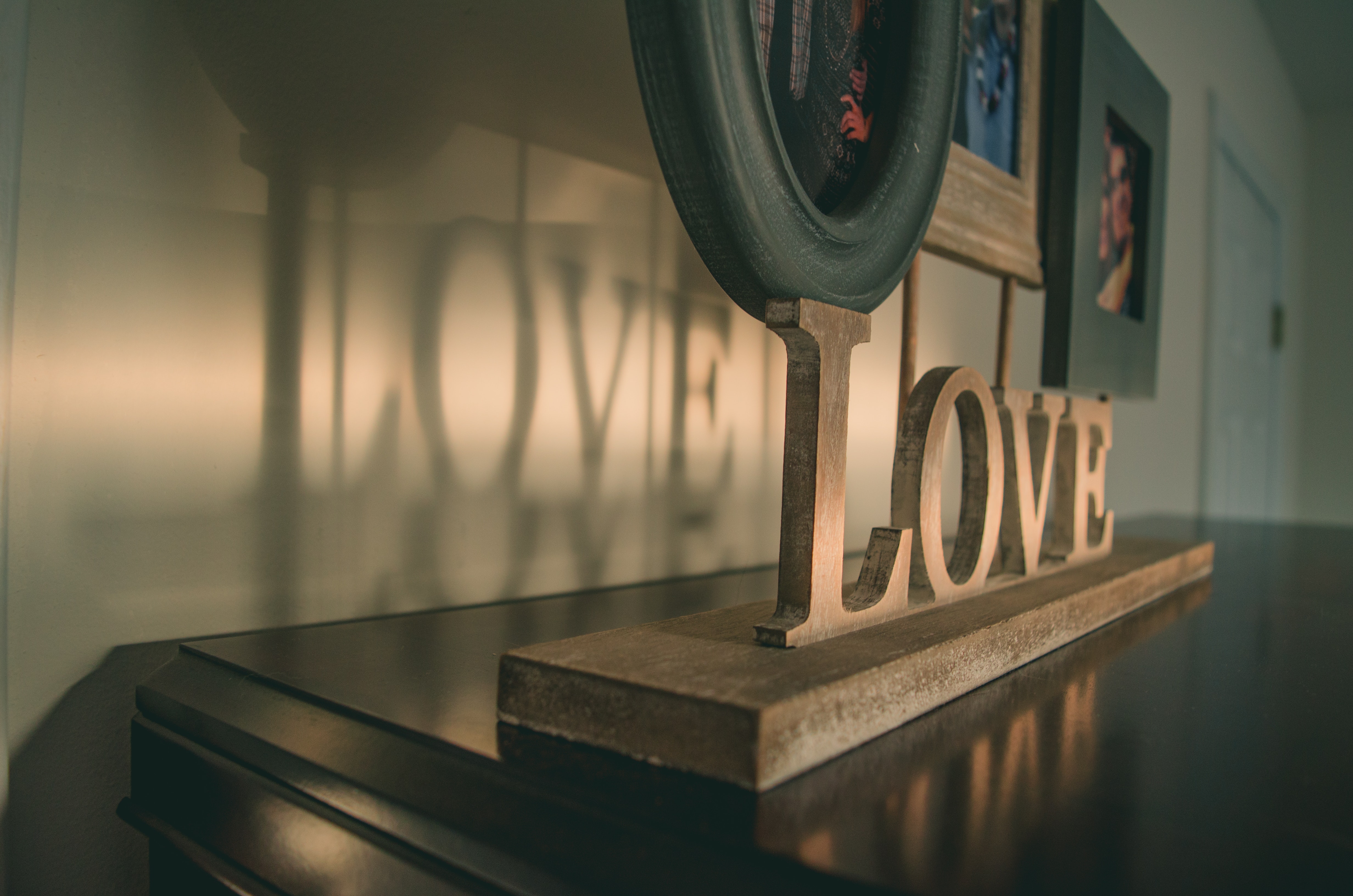 Brown wooden love free standing letter on black wooden surface photo