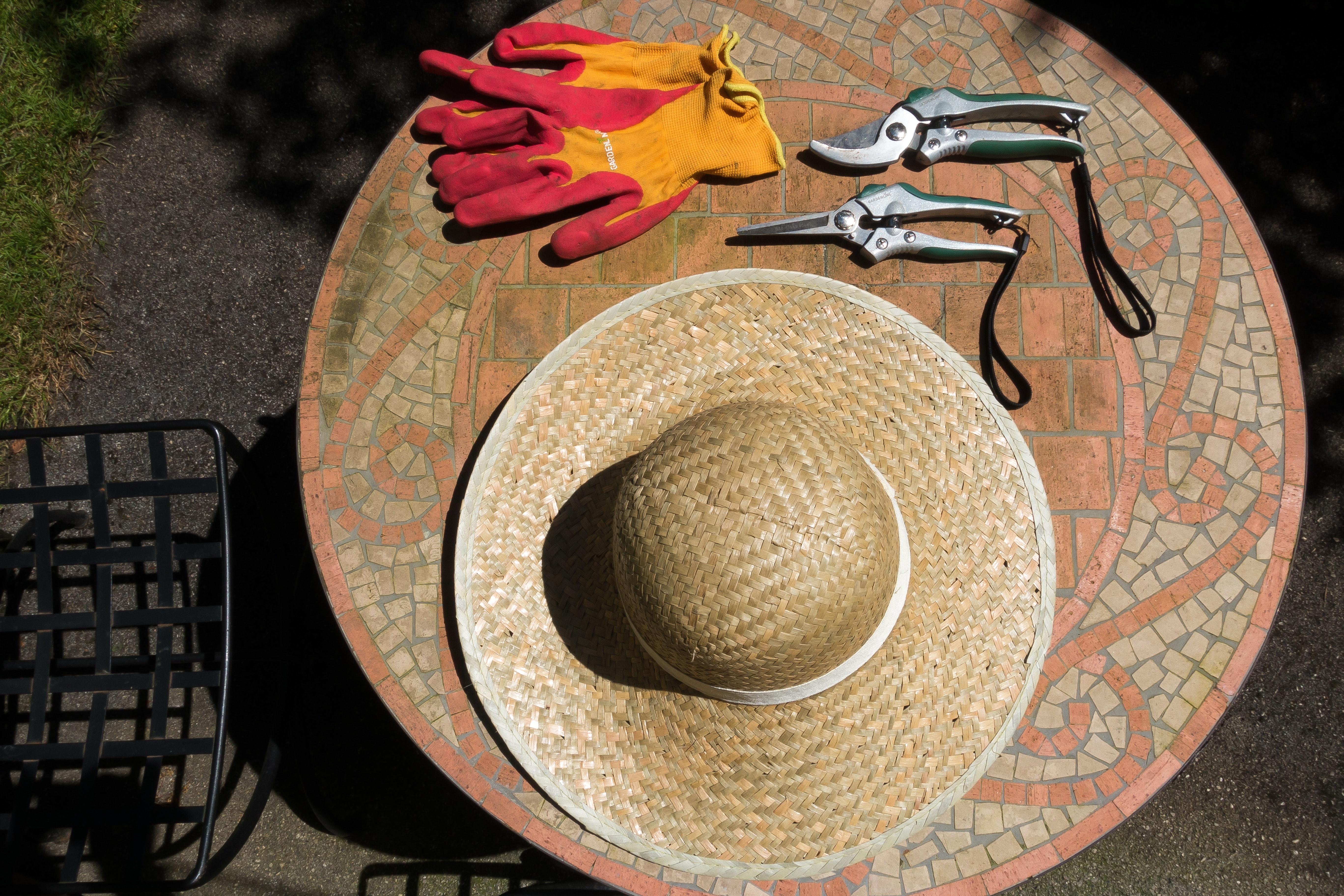 Brown woven hat over brown wooden round table top photo