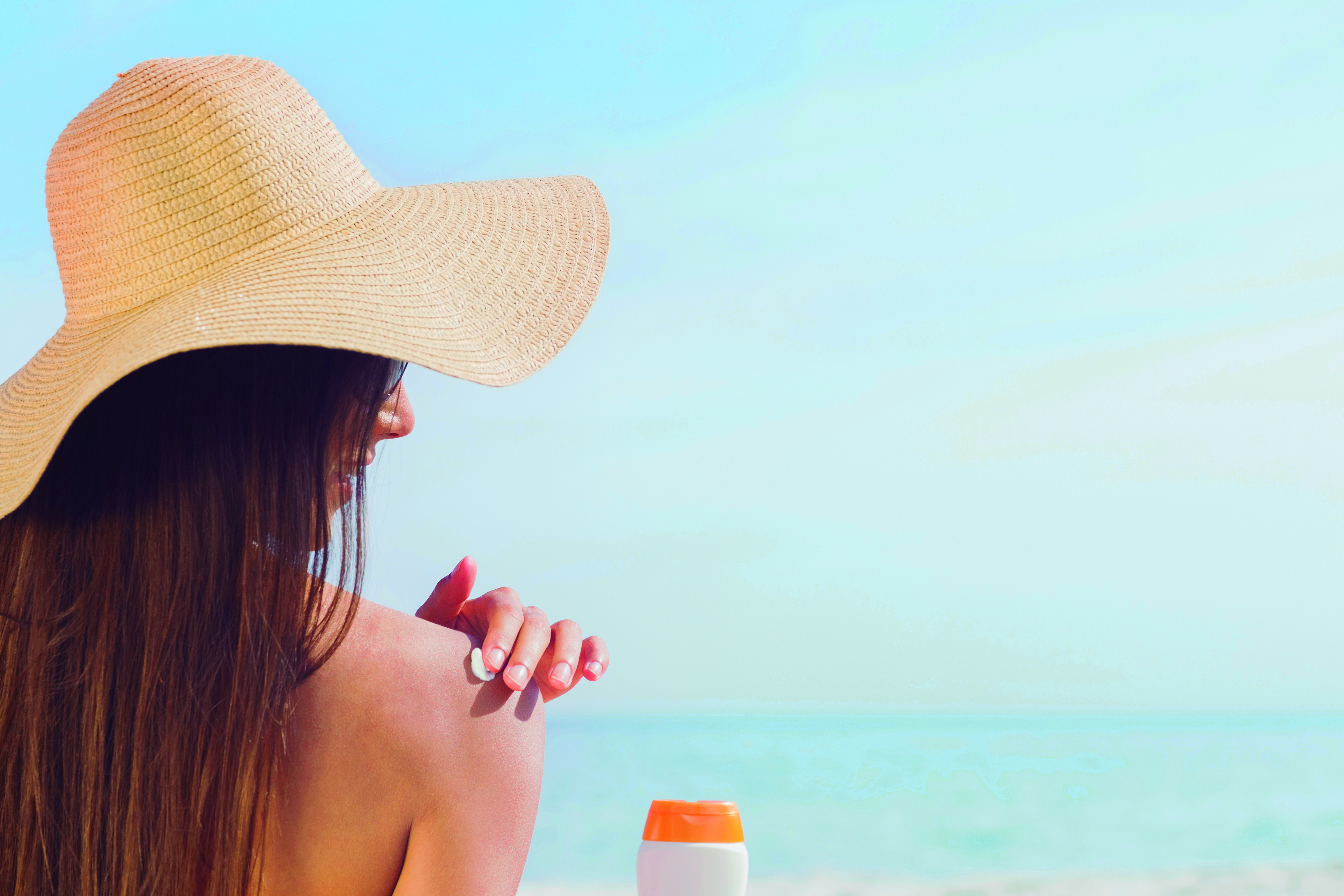 Brunette putting sunscreen on her shoulder, 20s, Straw hat, Relaxing, Scenic, HQ Photo