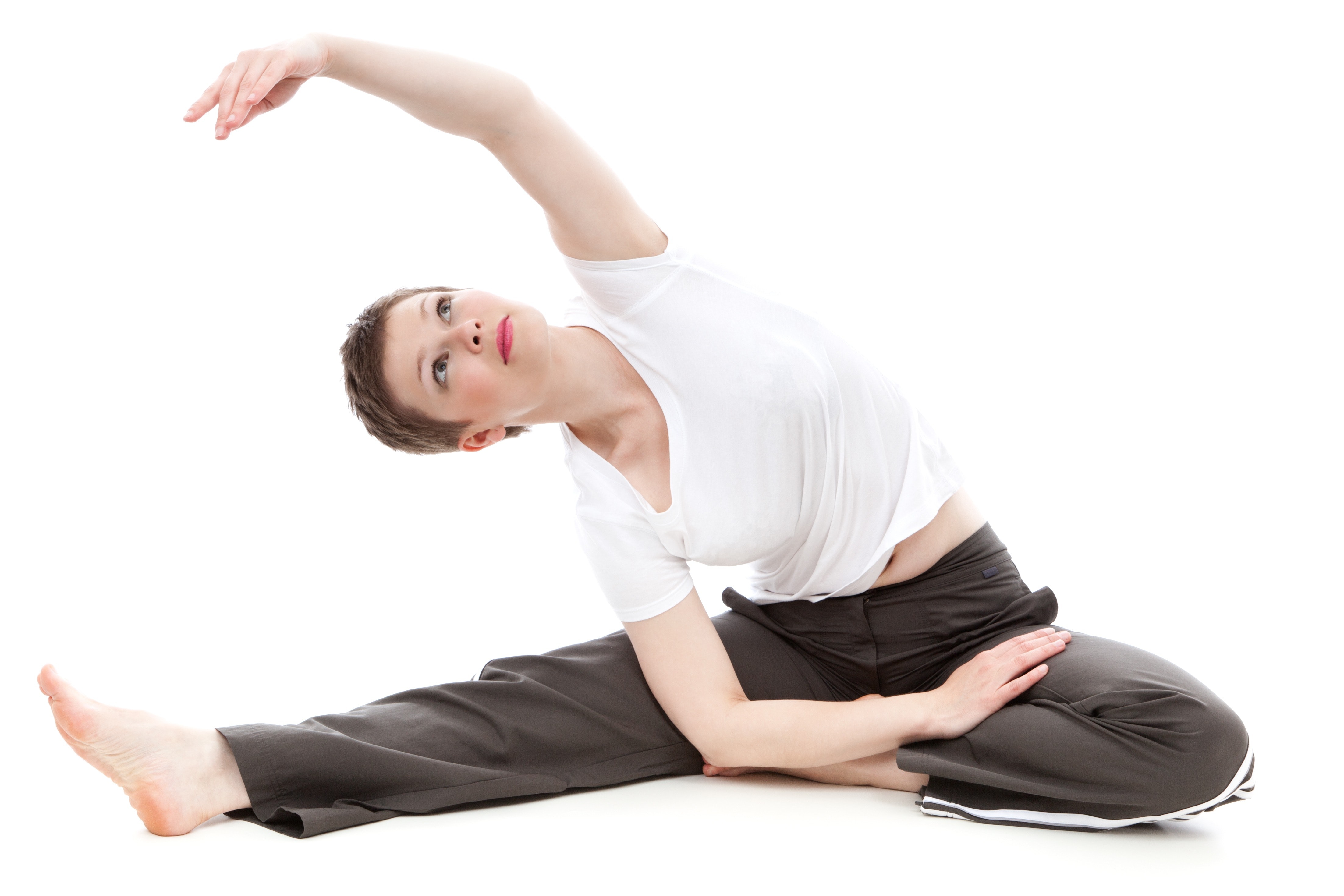 Brunette short haired woman stretching arm overhead in yoga pose photo