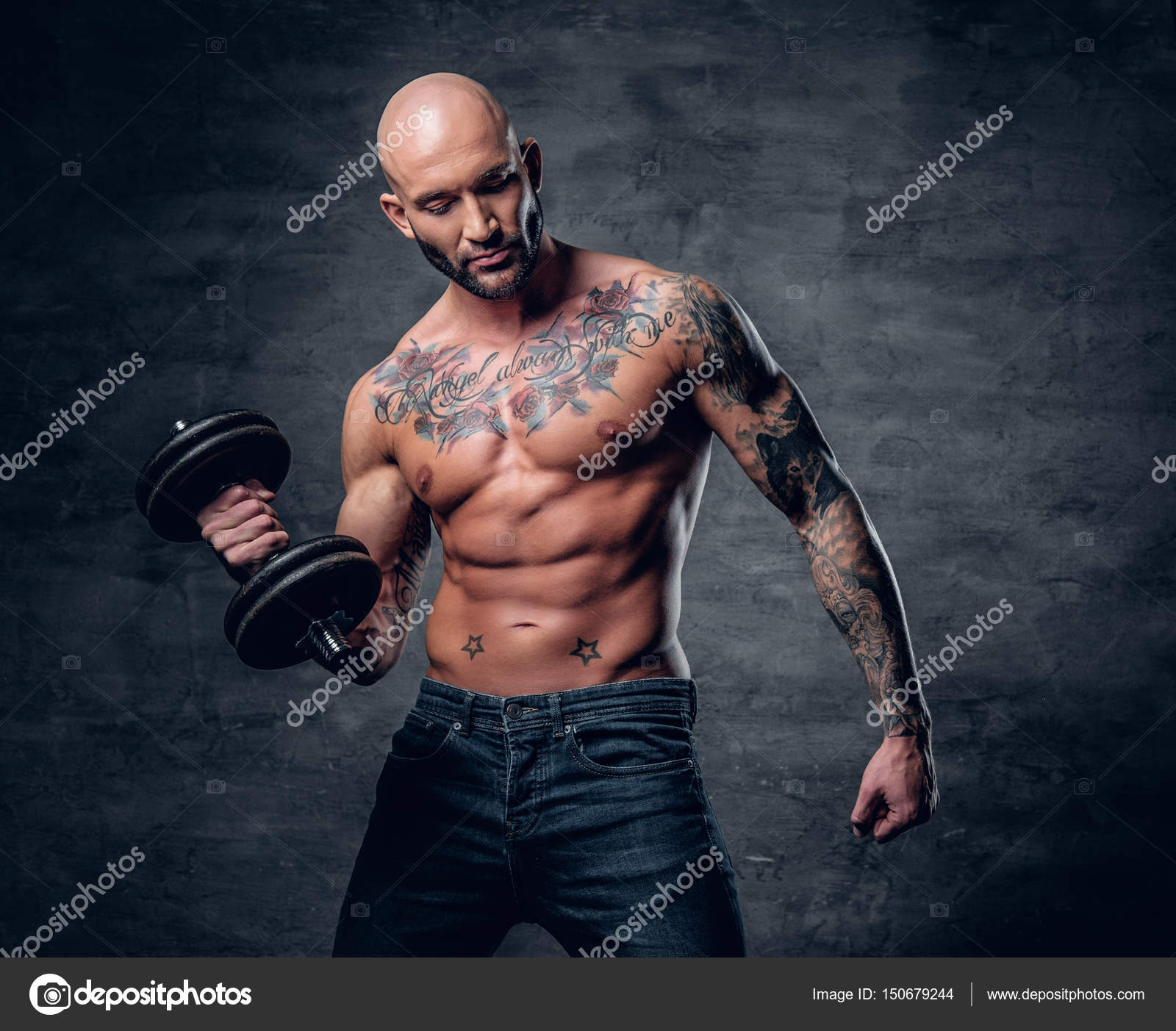 Brutal man with tattoos holds dumbbell — Stock Photo © fxquadro ...