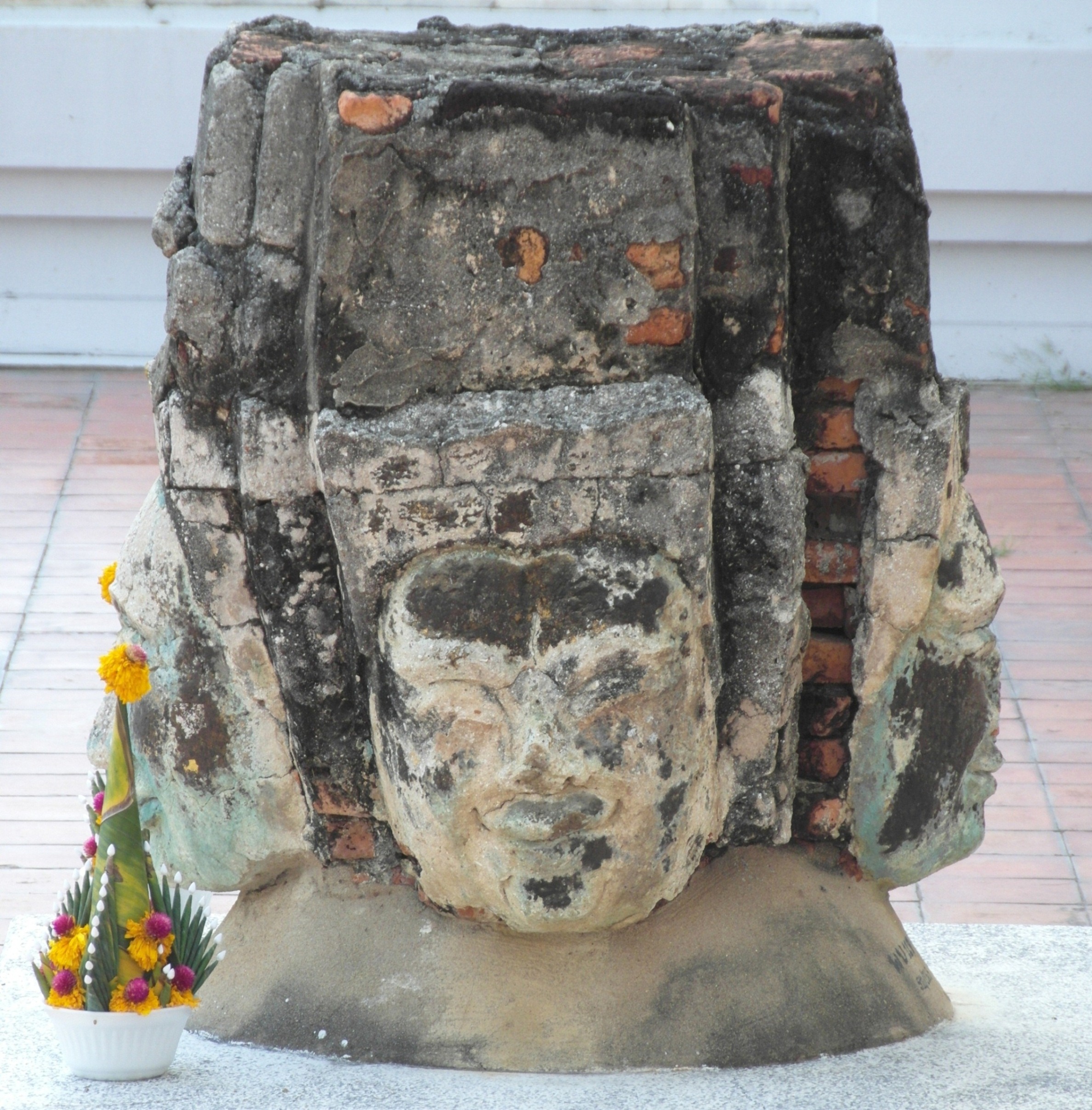 Buddha faces stone statue photo