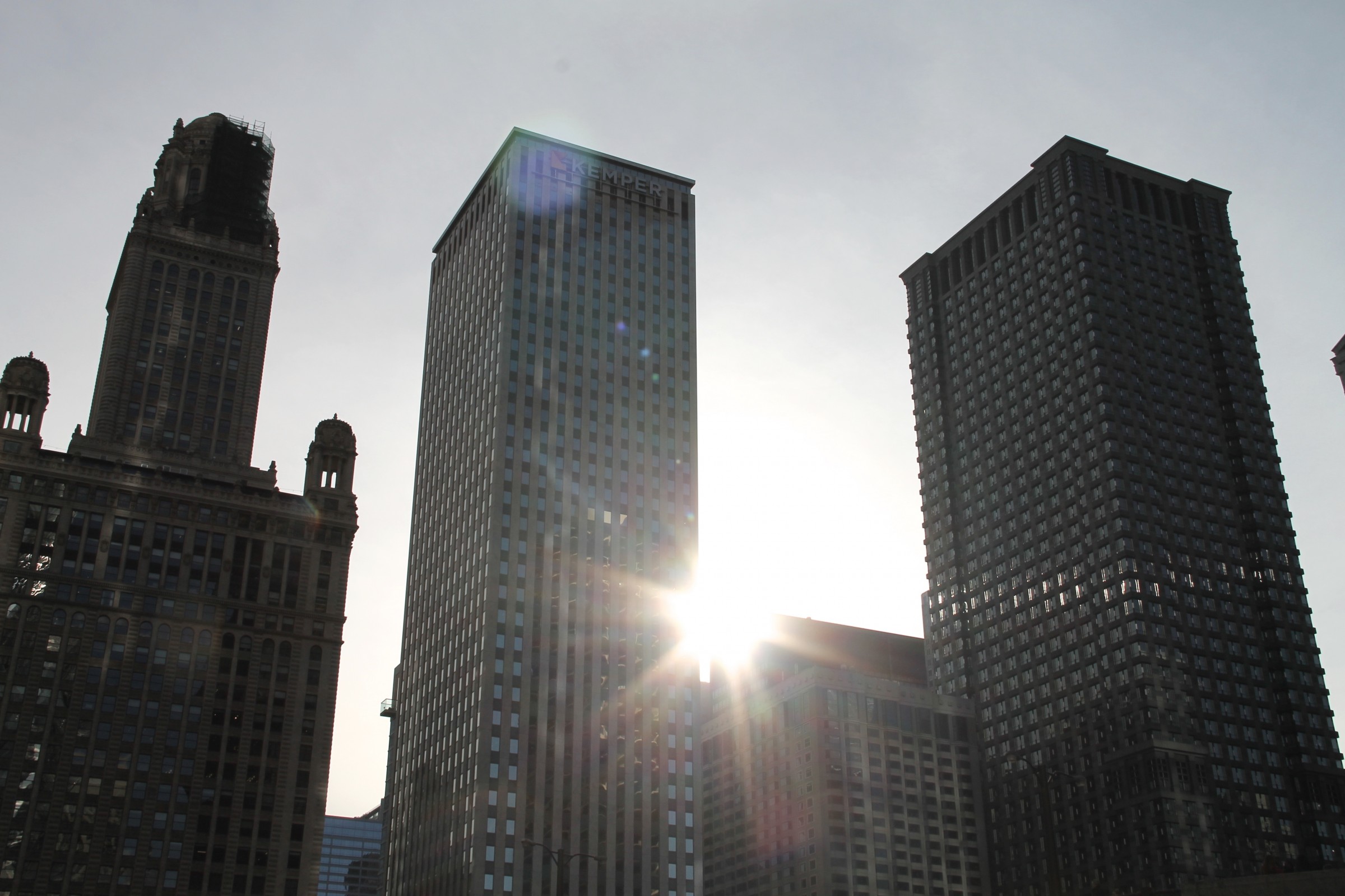 Free Stock Photo of Sun Shining Through 3 Skyscraper Buildings