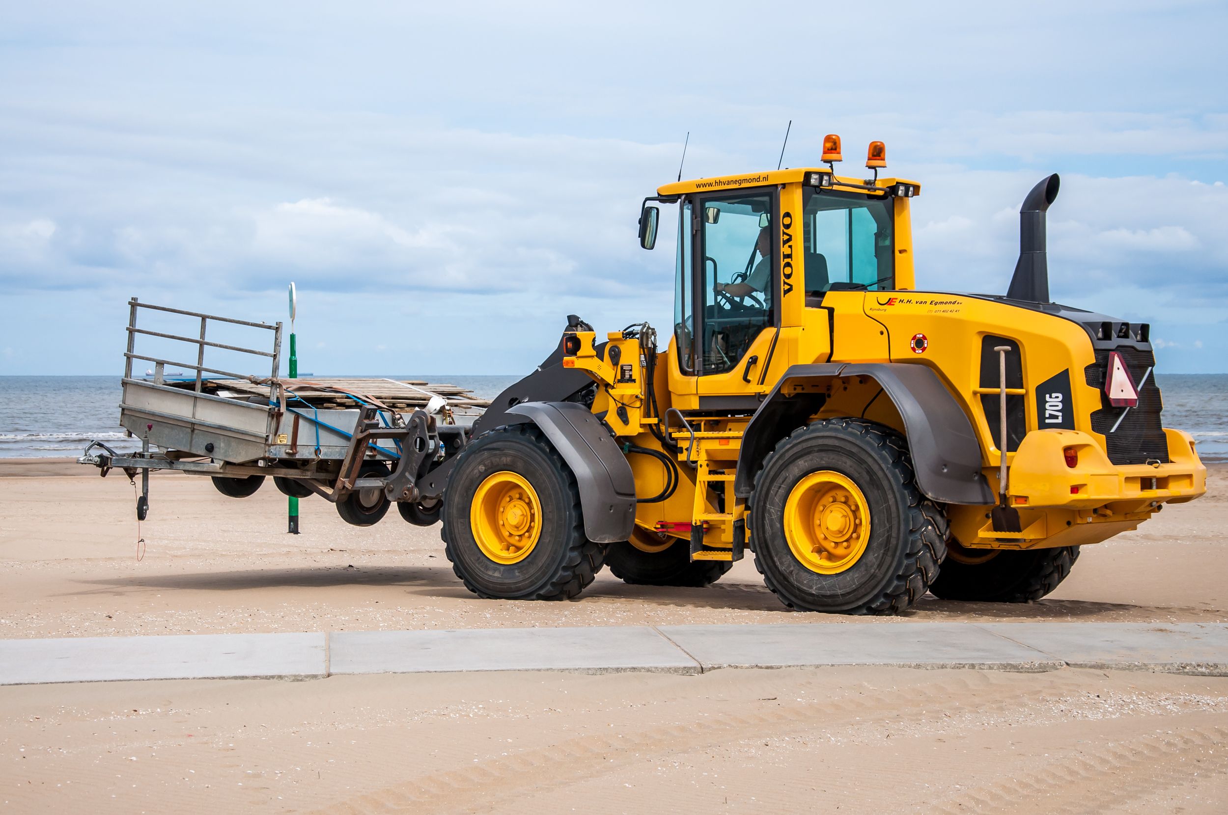 Bulldozer tractor working on a beach photo