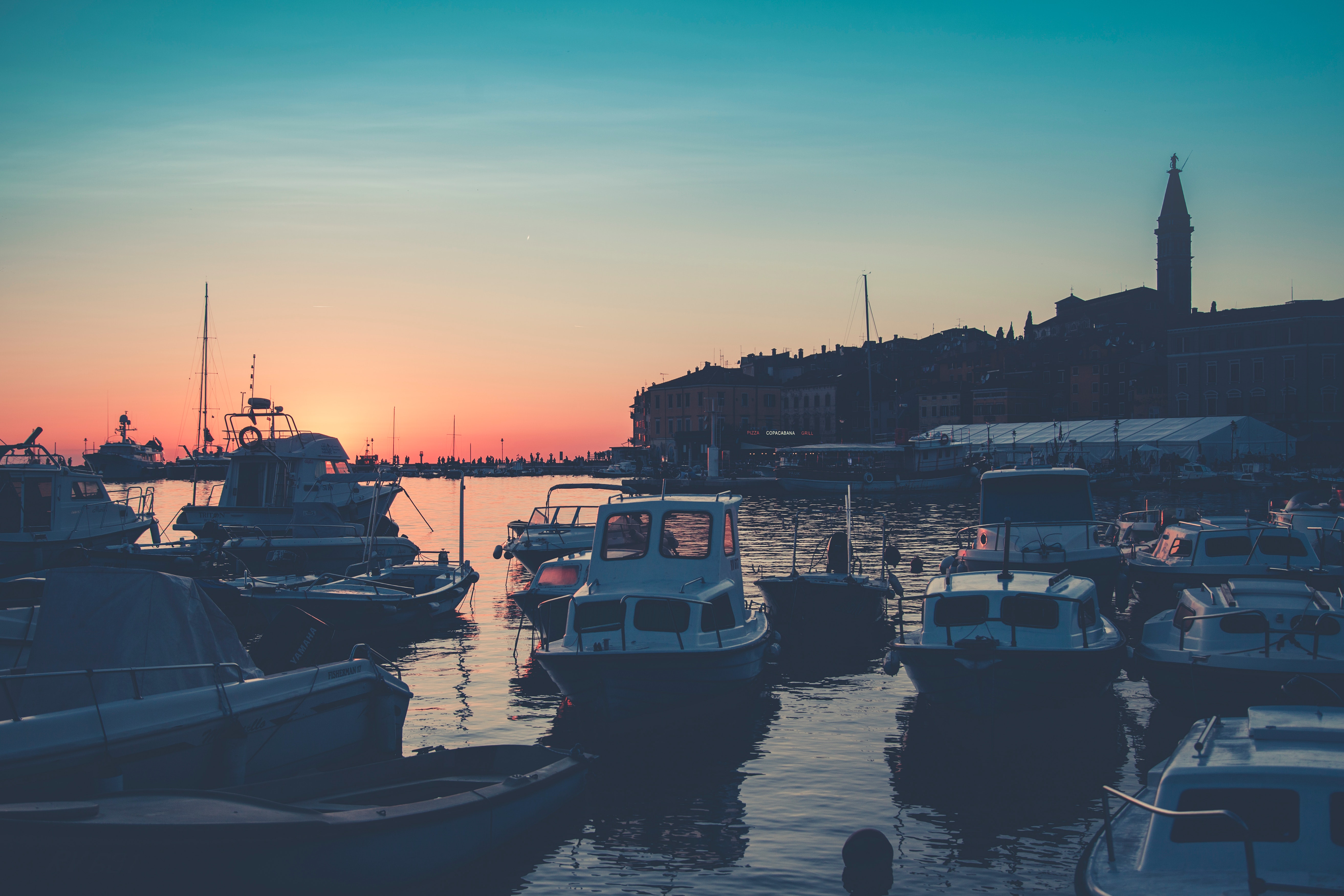 Bunch of boats on body of water during golden hour photo