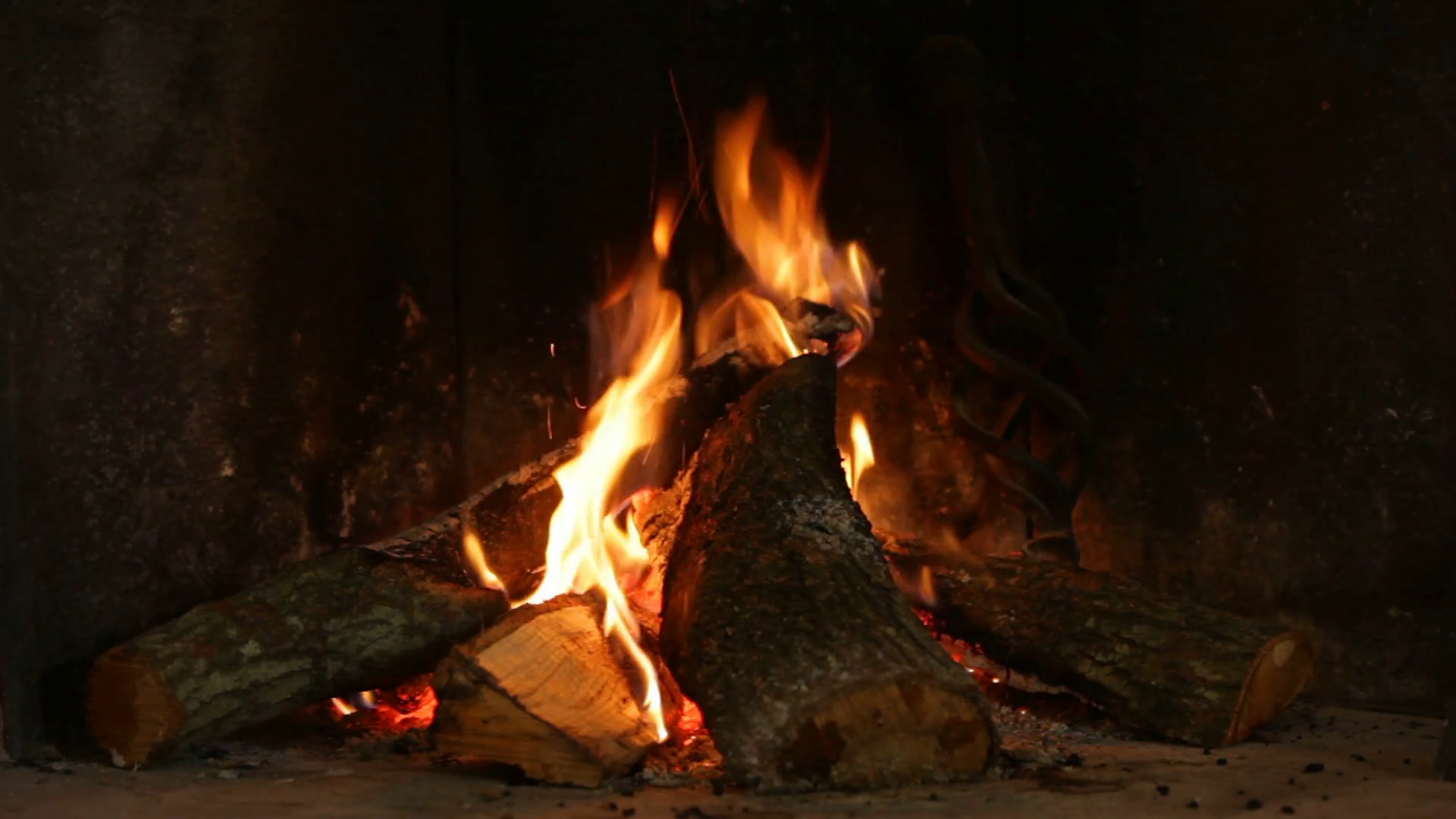 A warm fire in a chimney. Burning wood in the fireplace and the ...
