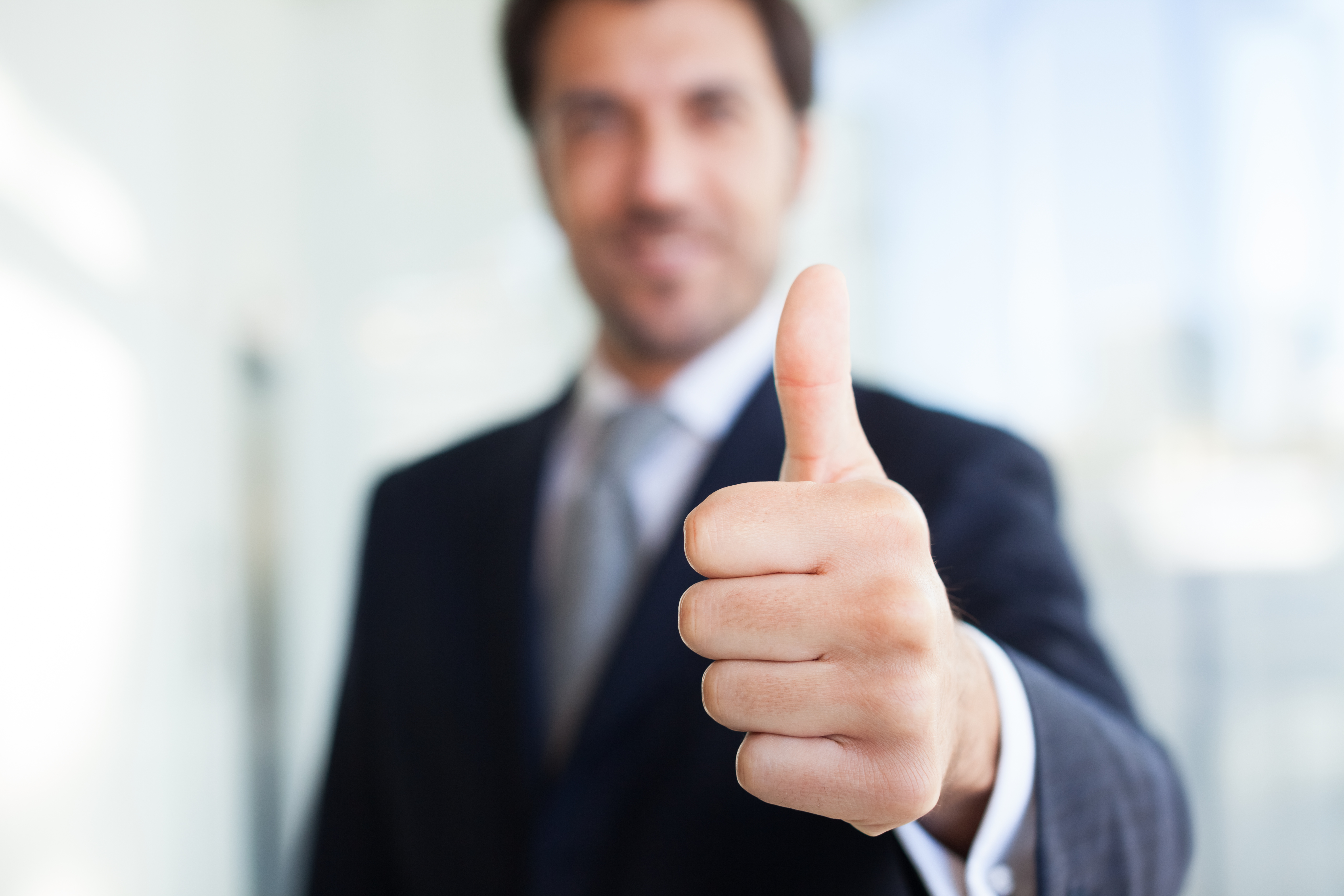 Businessman giving thumbs up - Natural Training