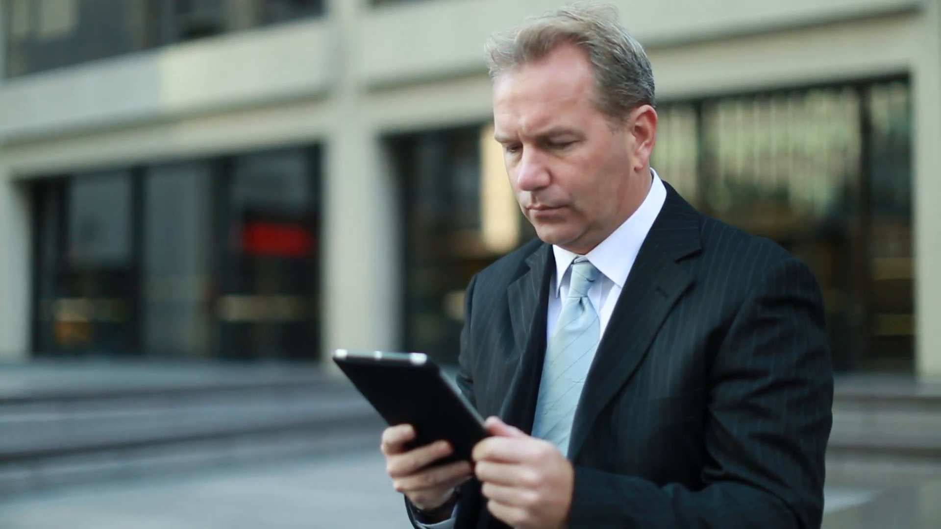 Caucasian middle aged businessman using tablet pc in New York City ...