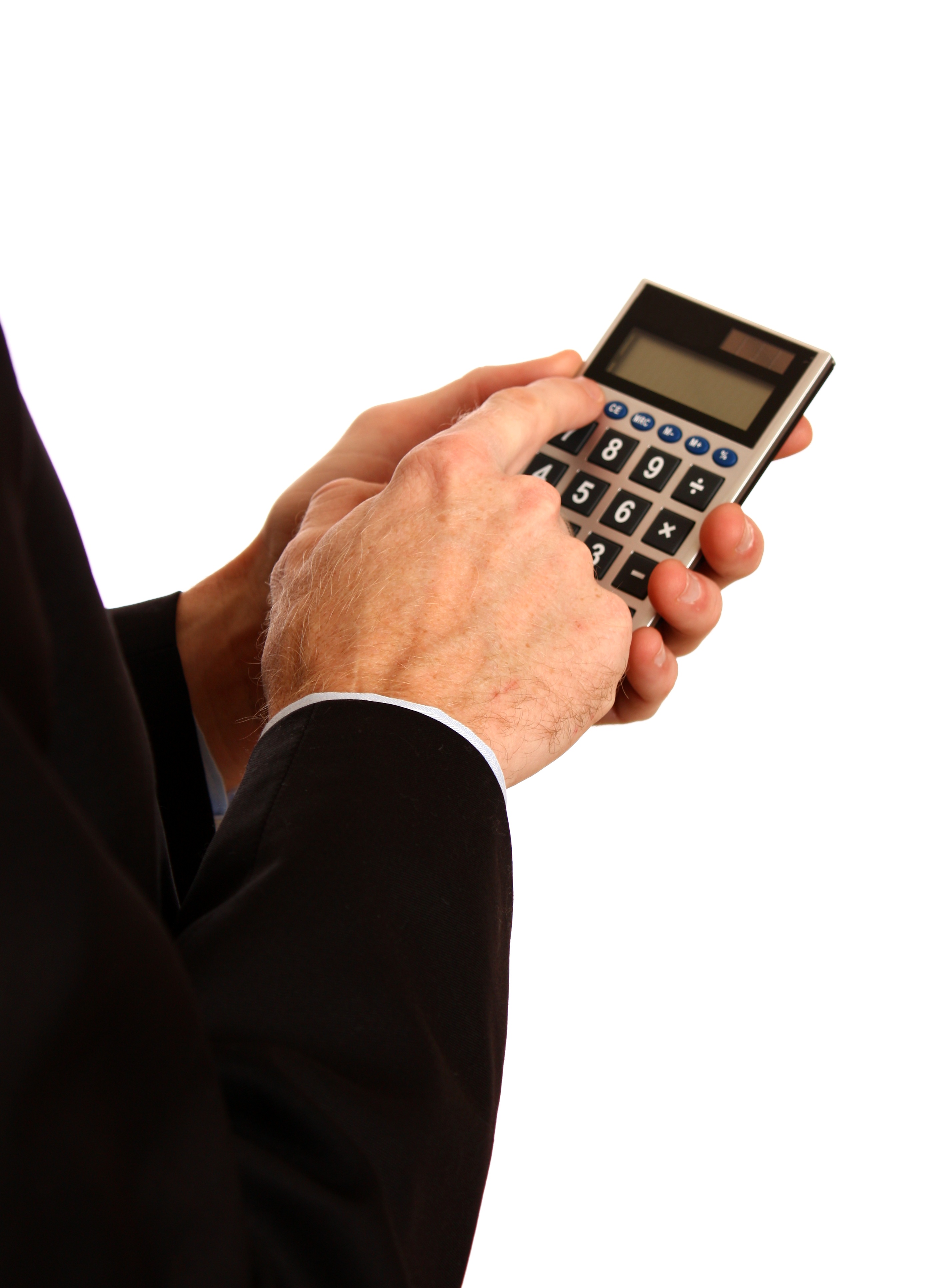 Businessman in a suit using a calculator photo