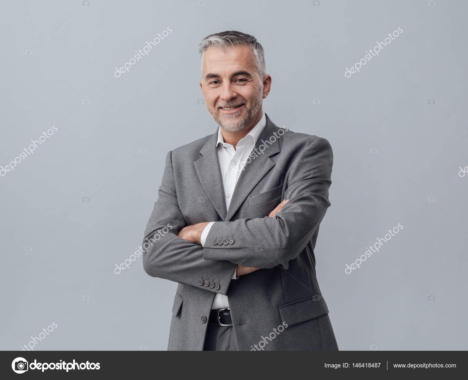 mature businessman posing with arms crossed — Stock Photo © stokkete ...