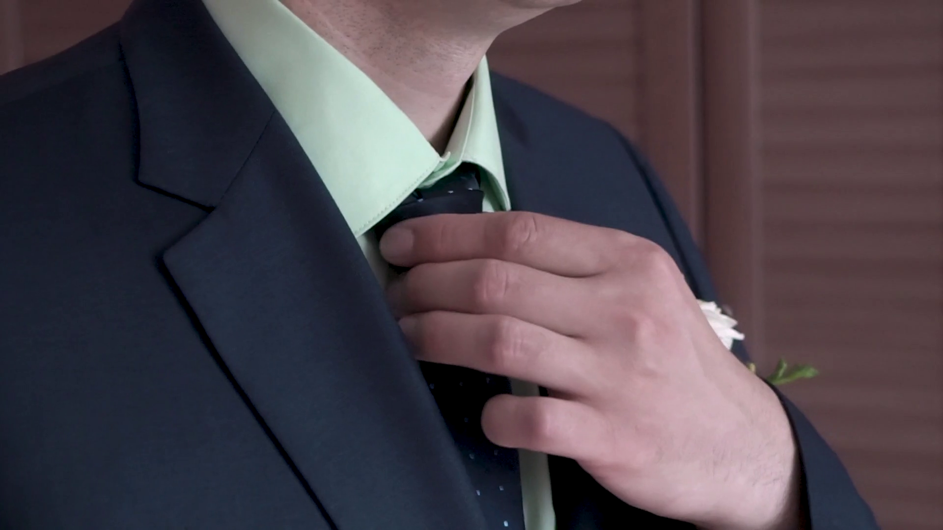 Portrait of businessman adjusting his necktie standing in office ...