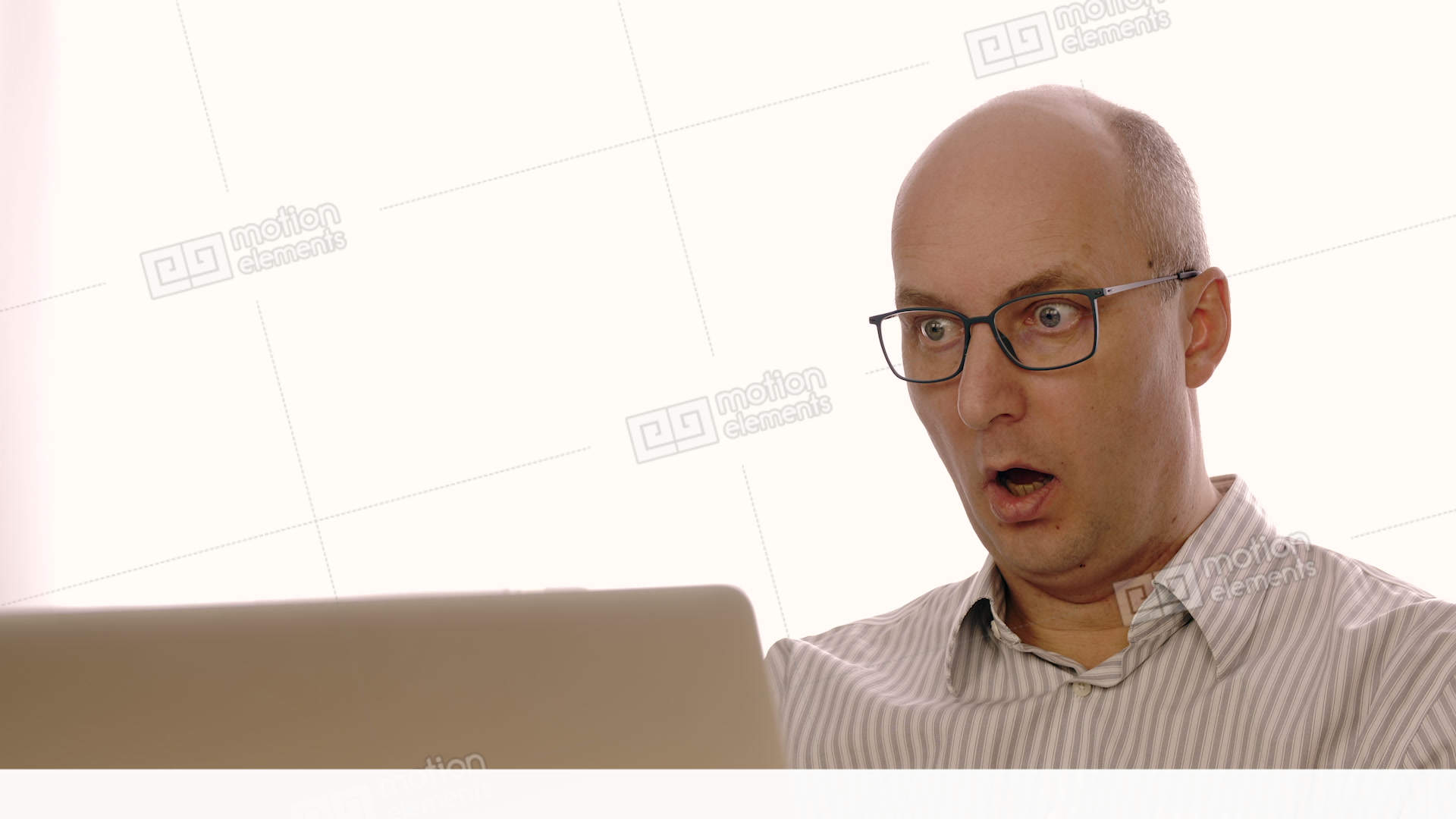 Surprised Bald Businessman In Glasses Looking At Laptop Screen With ...