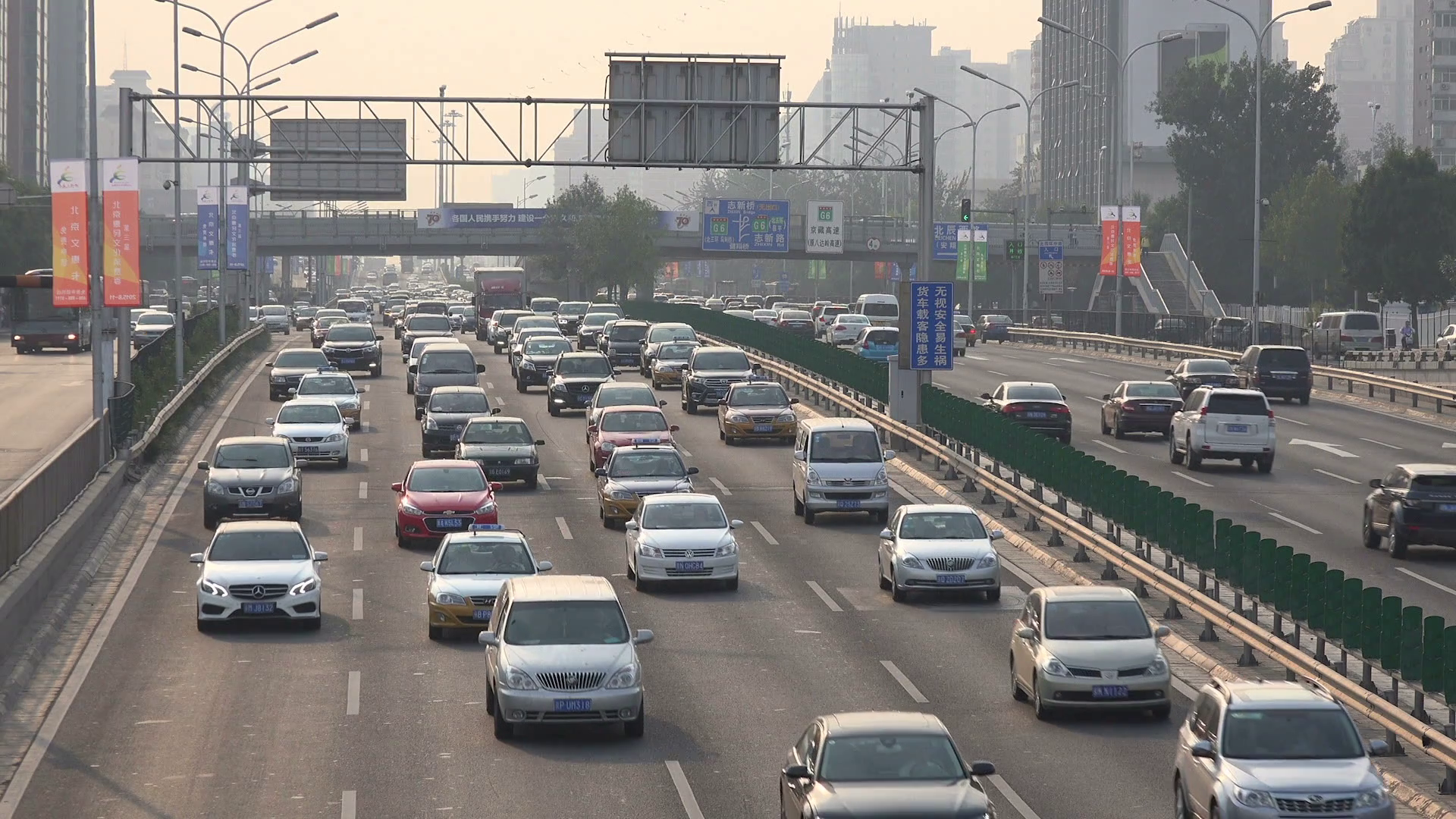 Busy traffic drives over a highway in Beijing, smog and air ...