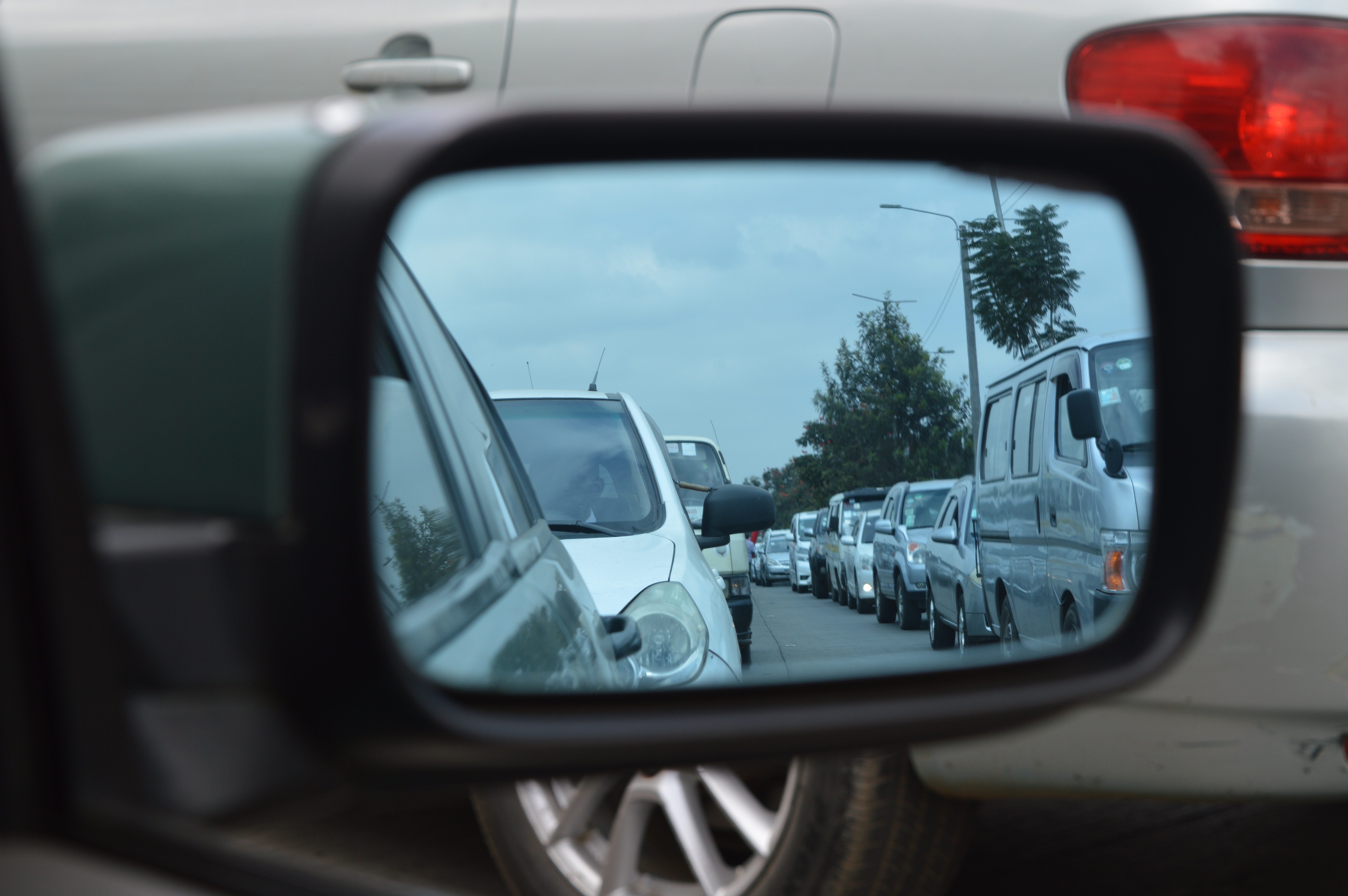 Car side mirror showing heavy traffic photo