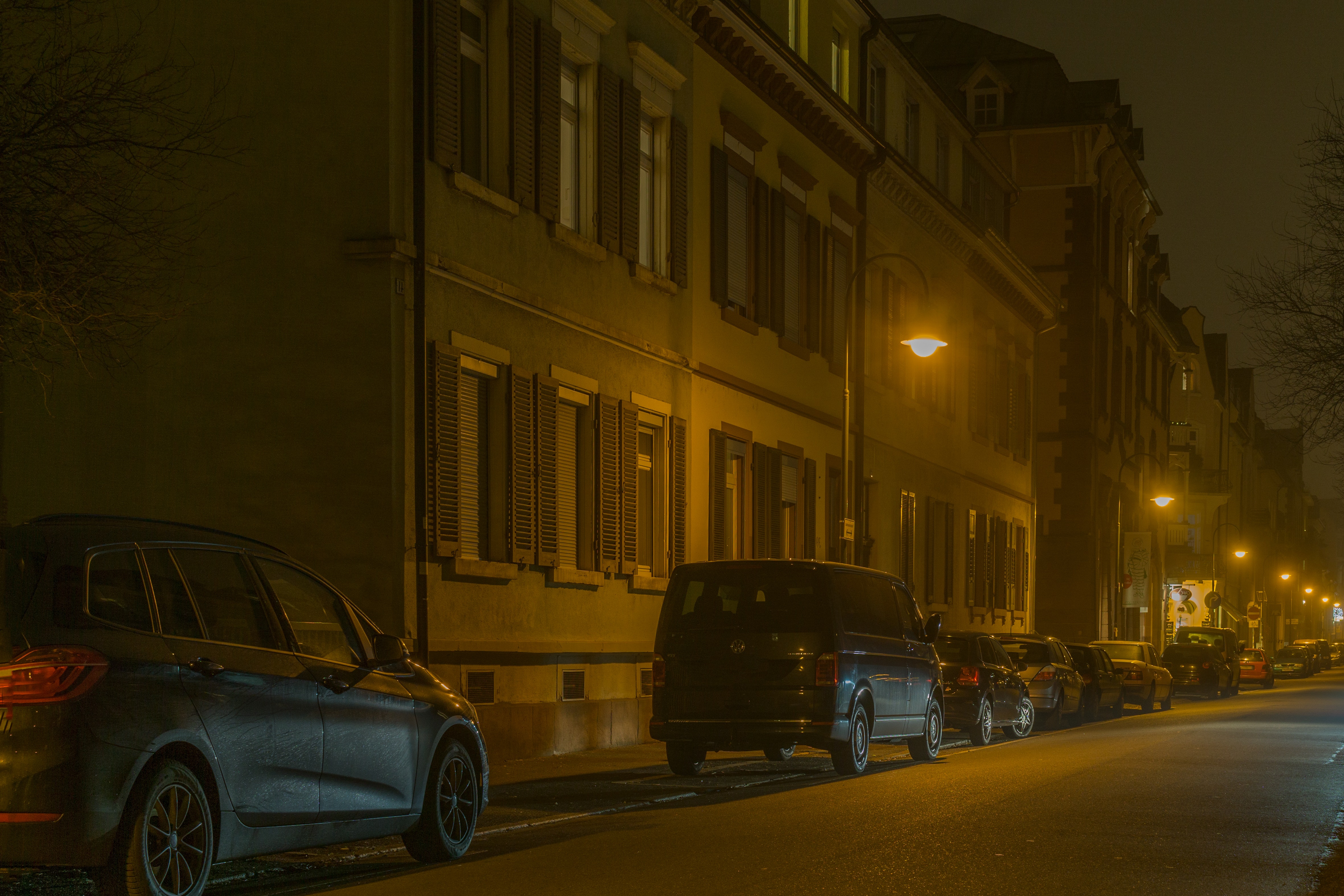 Cars in illuminated city at night photo