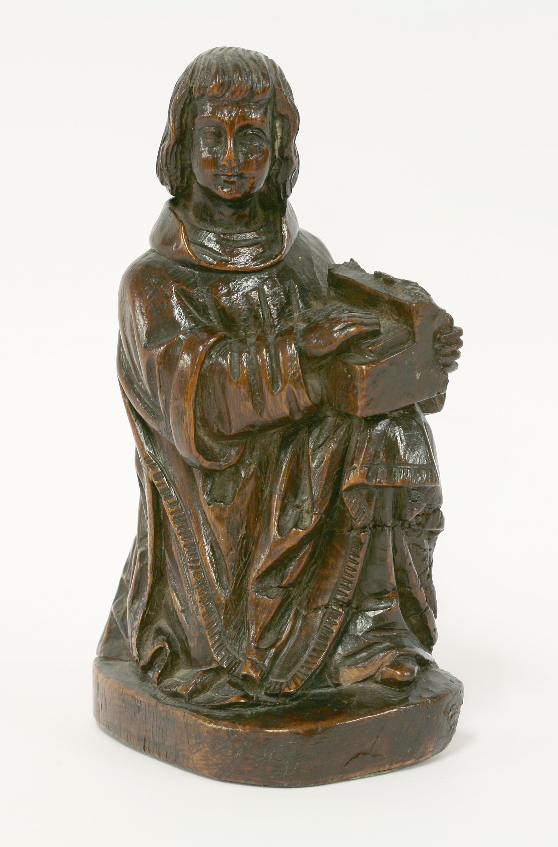 A small carved figure of a musician, 16th century, the figure ...