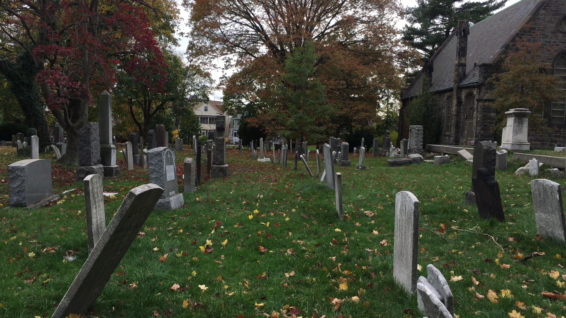 mysterious man visiting NYC cemetery graveyard on cloudy, autumn day ...