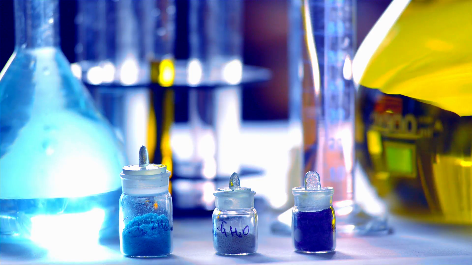Jars with chemicals, flasks with blue and yellow reagents, test ...