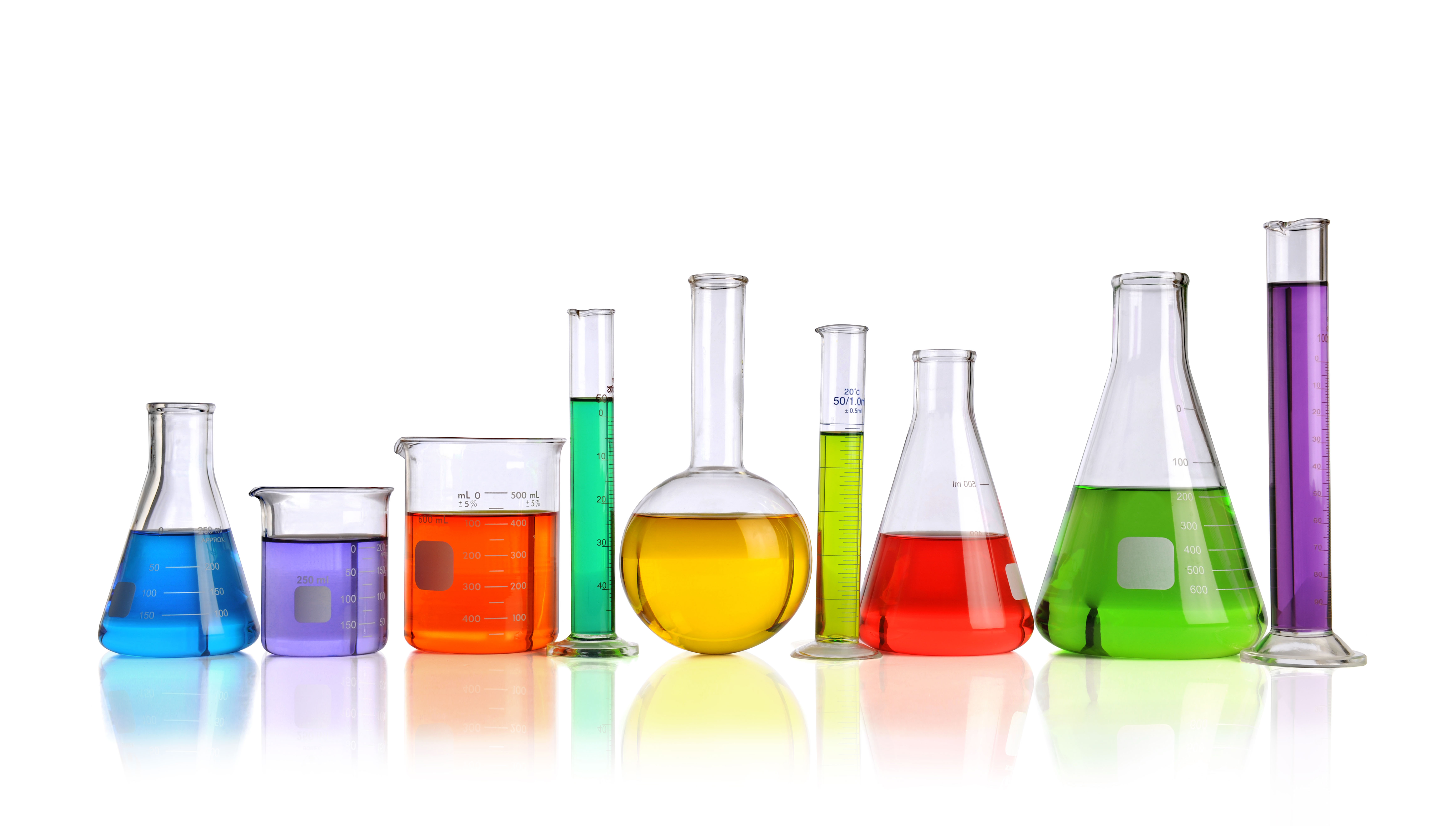 Laboratory glassware with liquids of different colors with ...
