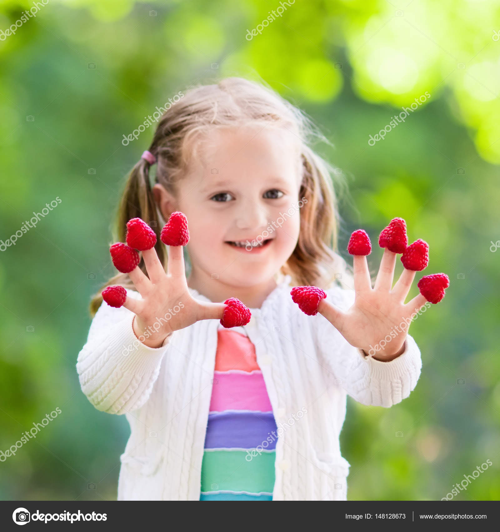 Child picking and eating raspberry in summer — Stock Photo ...