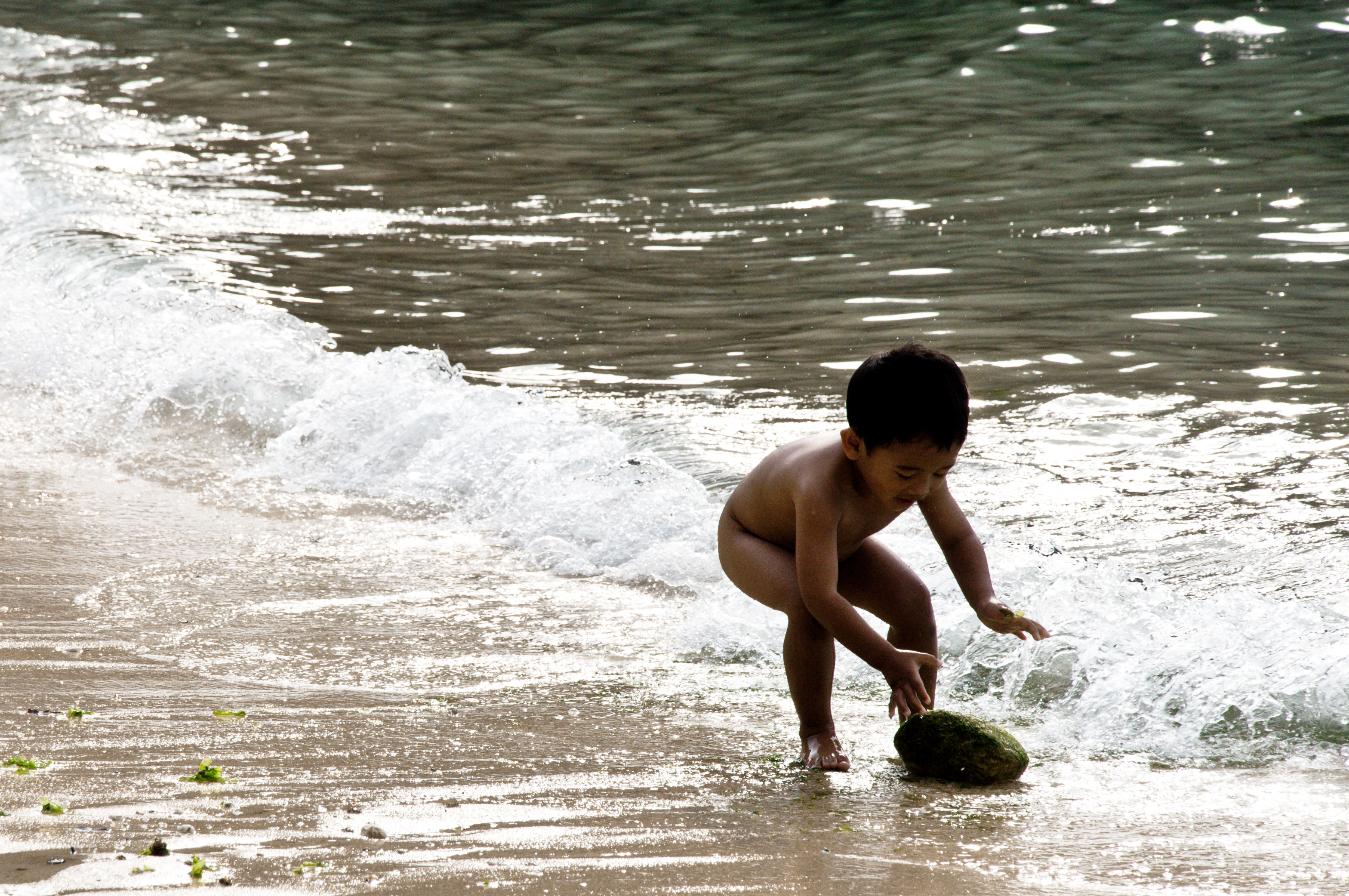 Child playing in ocean photo