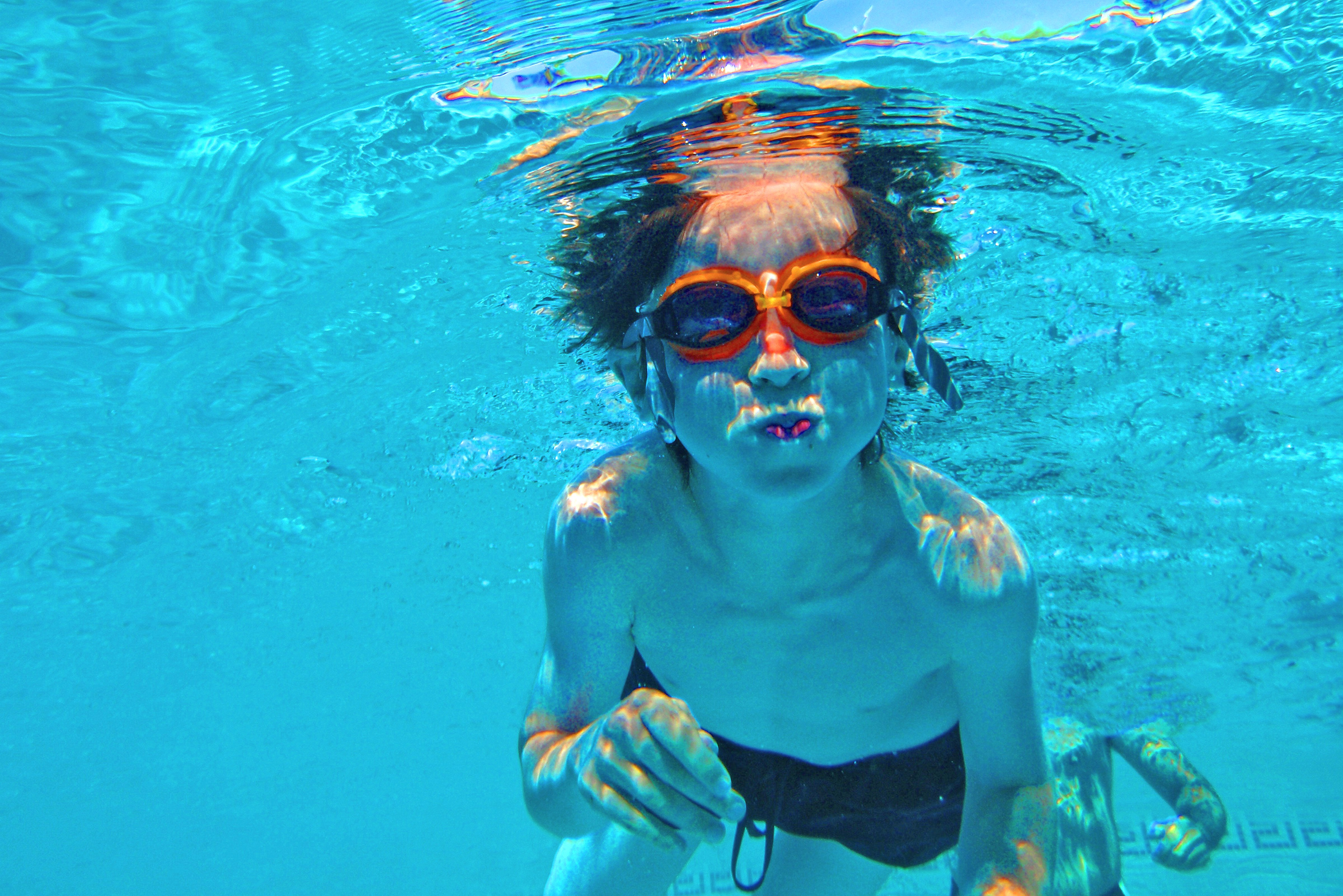Child swimming underwater photo