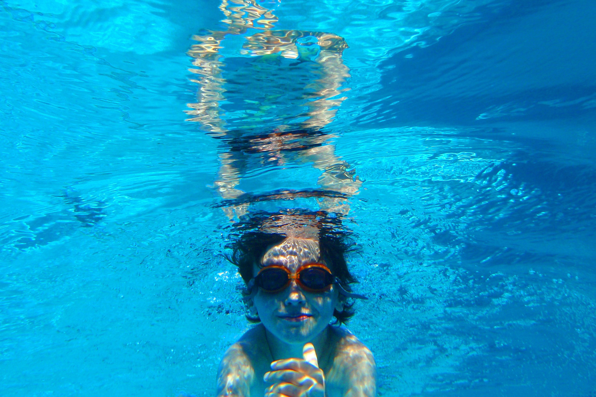 Child swimming underwater photo