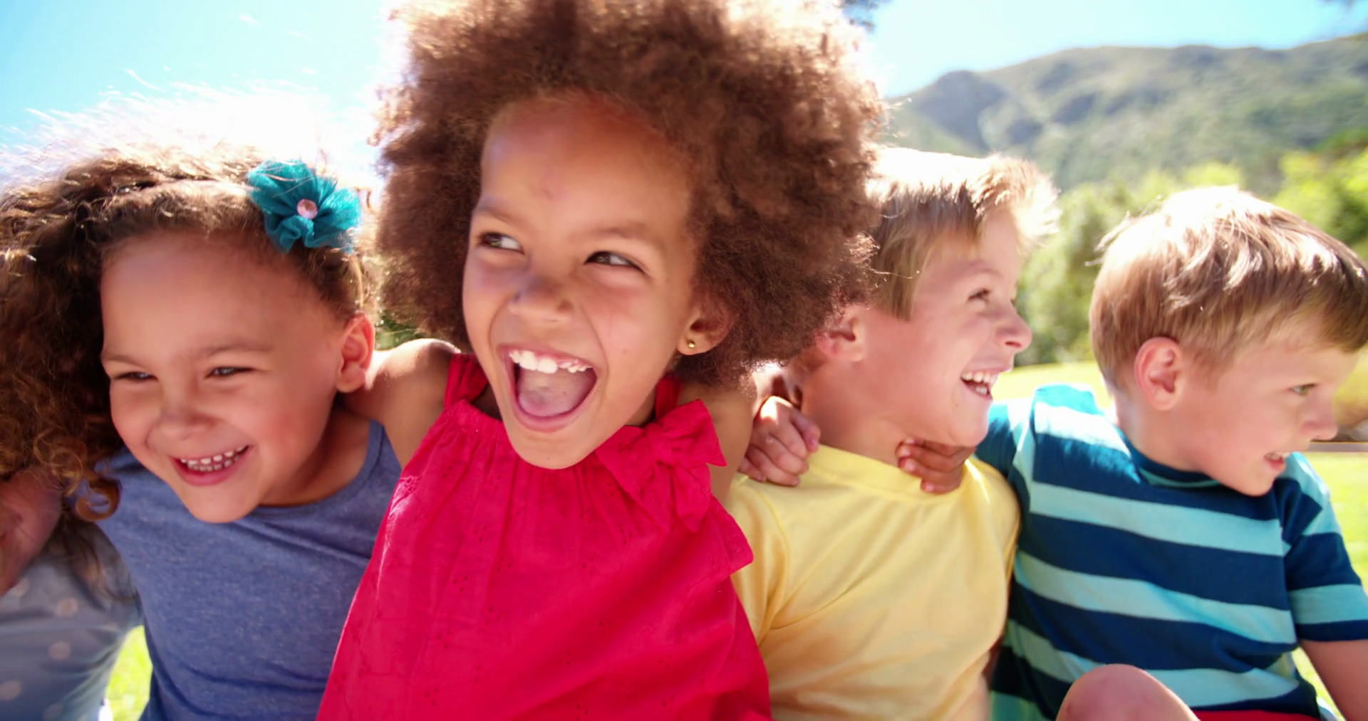 Mixed racial group of friendly children laughing together Stock ...