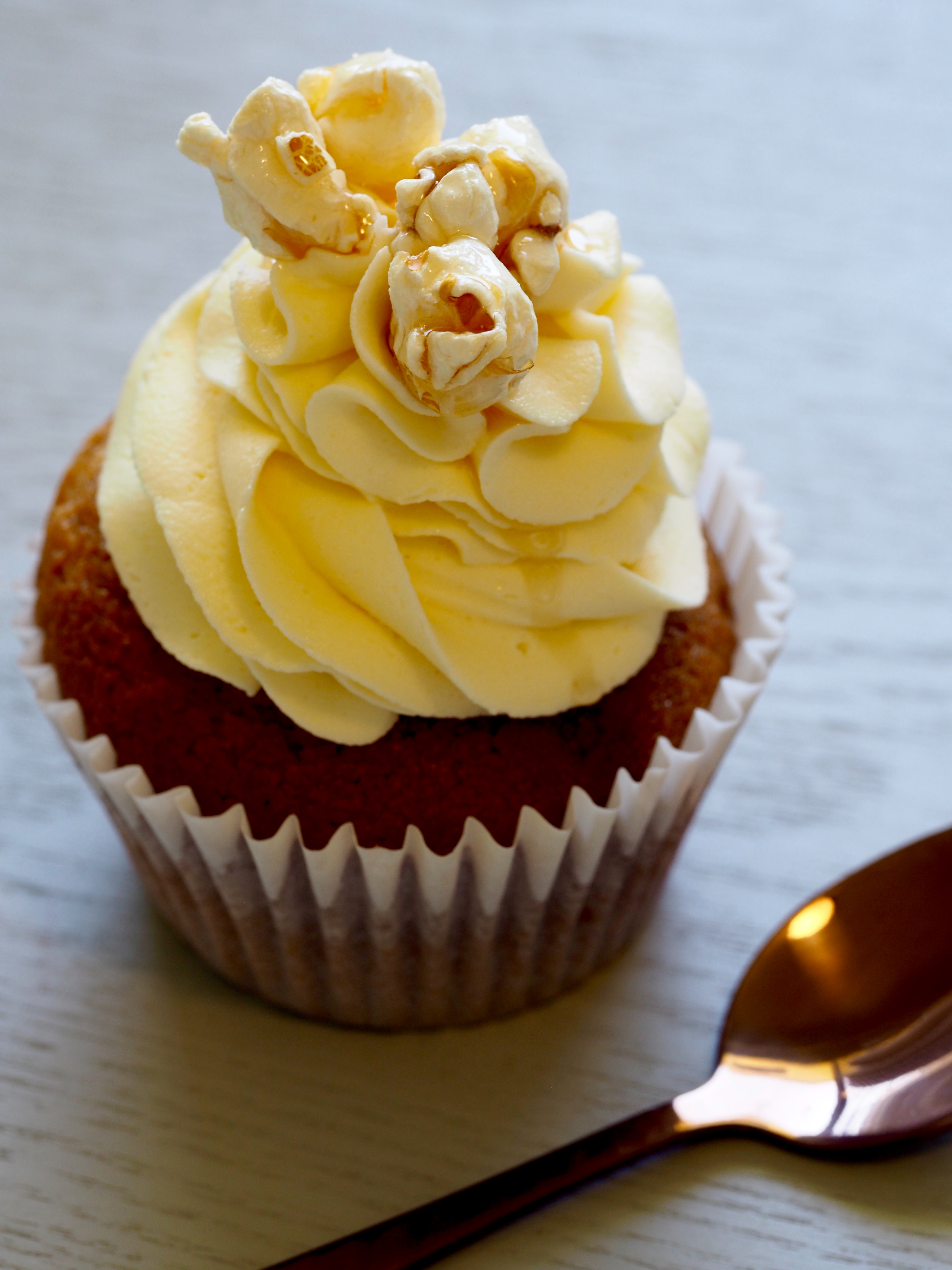 Chocolate cupcake with yellow icing on top photo