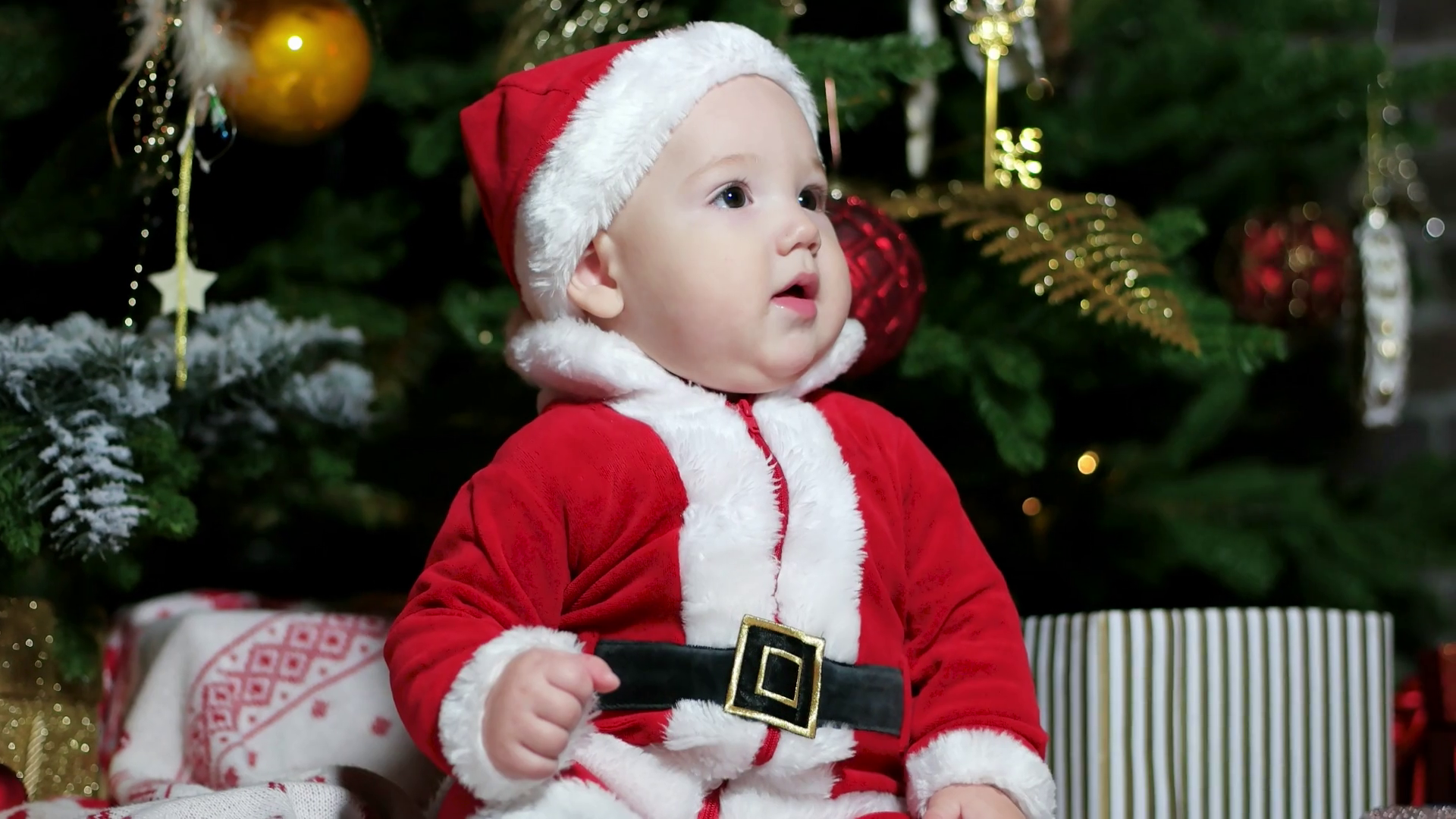 cute boy playing near the Christmas tree, Little baby dressed in ...