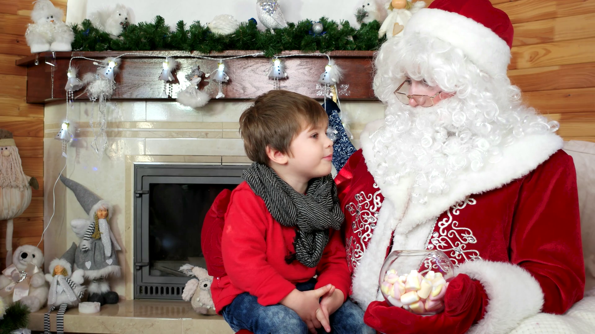 santa welcomes little boy, kid getting christmas present sitting on ...